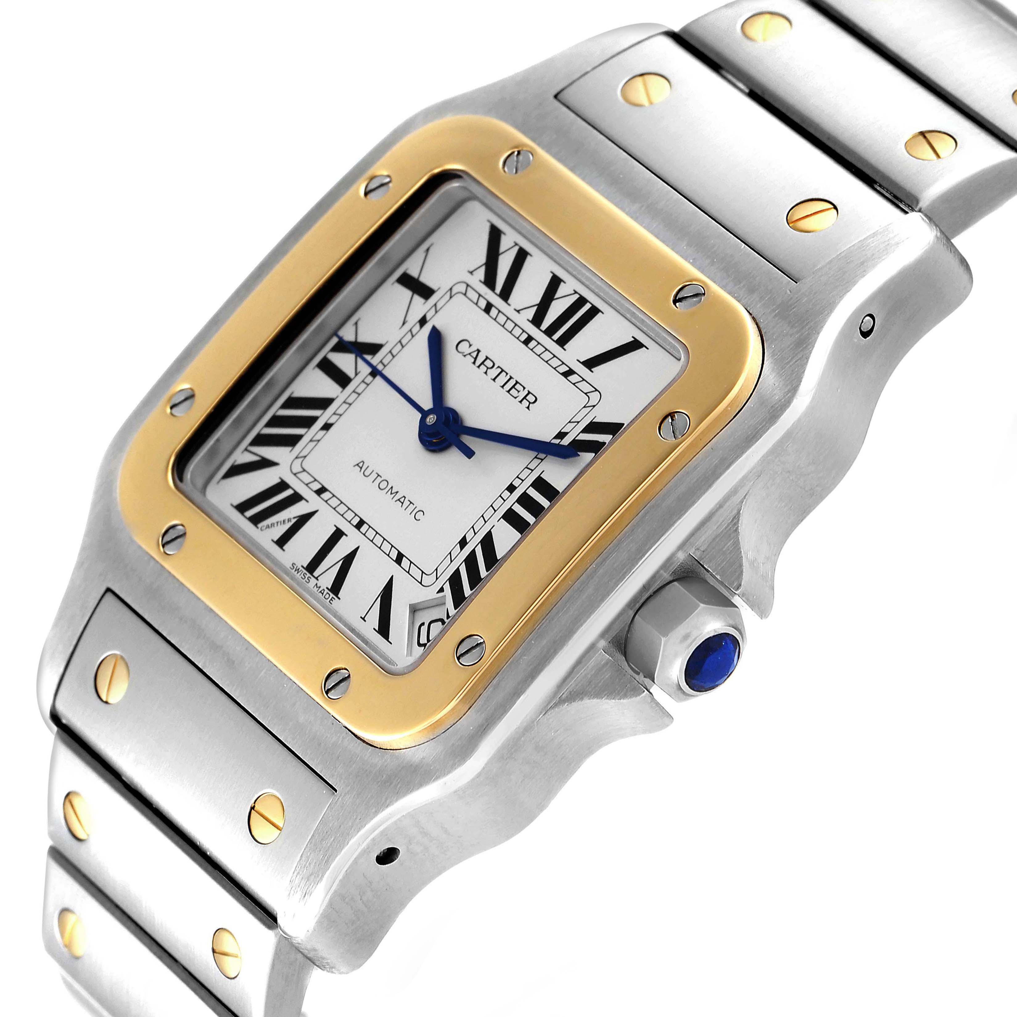 This image shows a close-up angled view of the face and bracelet of a Cartier Santos W20099C4 Men's Steel and Gold (two tone) Silver Dial W20099C4 Men's Steel and Gold (two tone) Silver Dial watch.