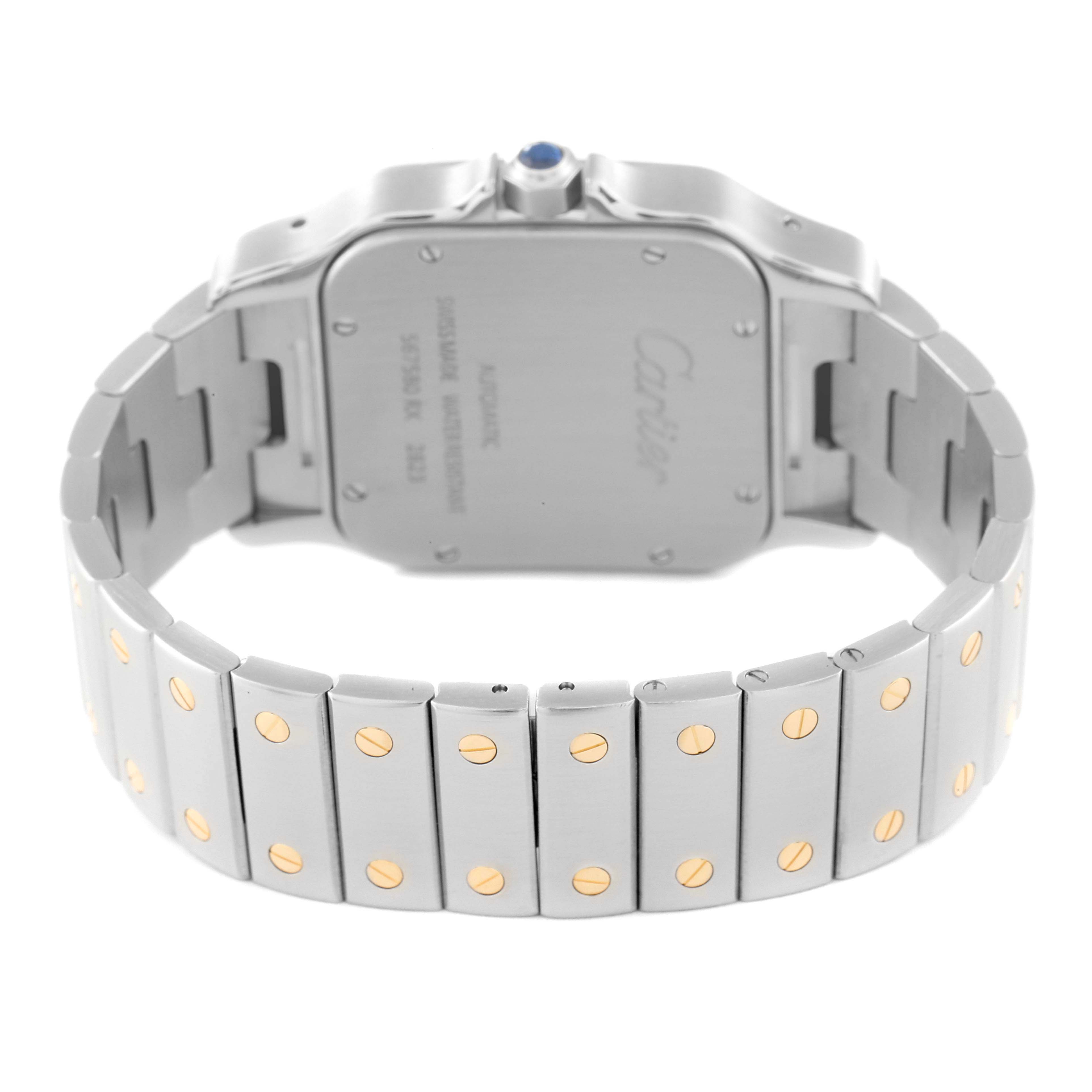 The image shows the back and bracelet of a Santos model watch by Cartier, highlighting the clasp and case back.