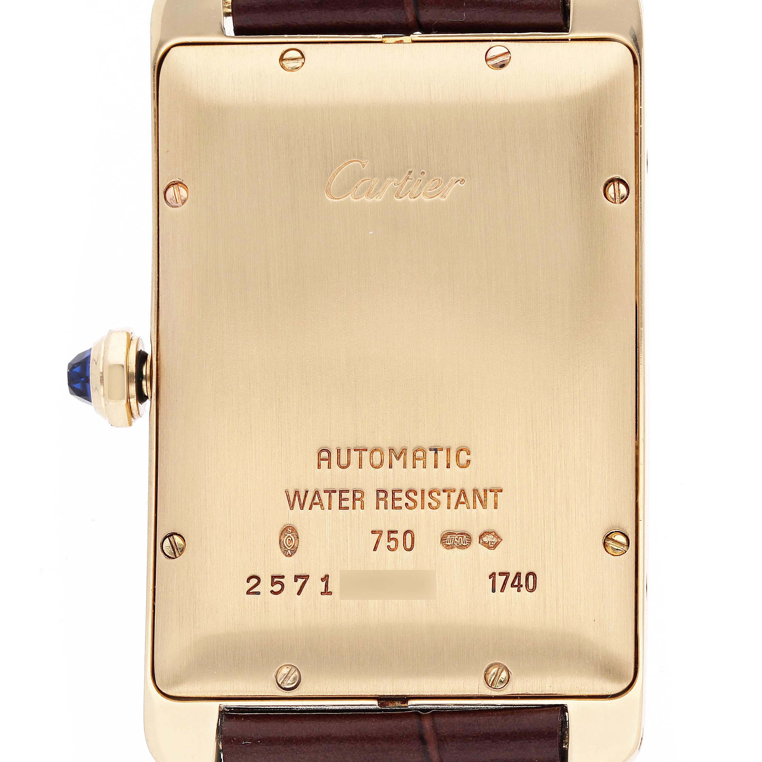 The image shows the back of the Cartier Tank Américaine watch, highlighting its inscriptions and crown with a blue gemstone.