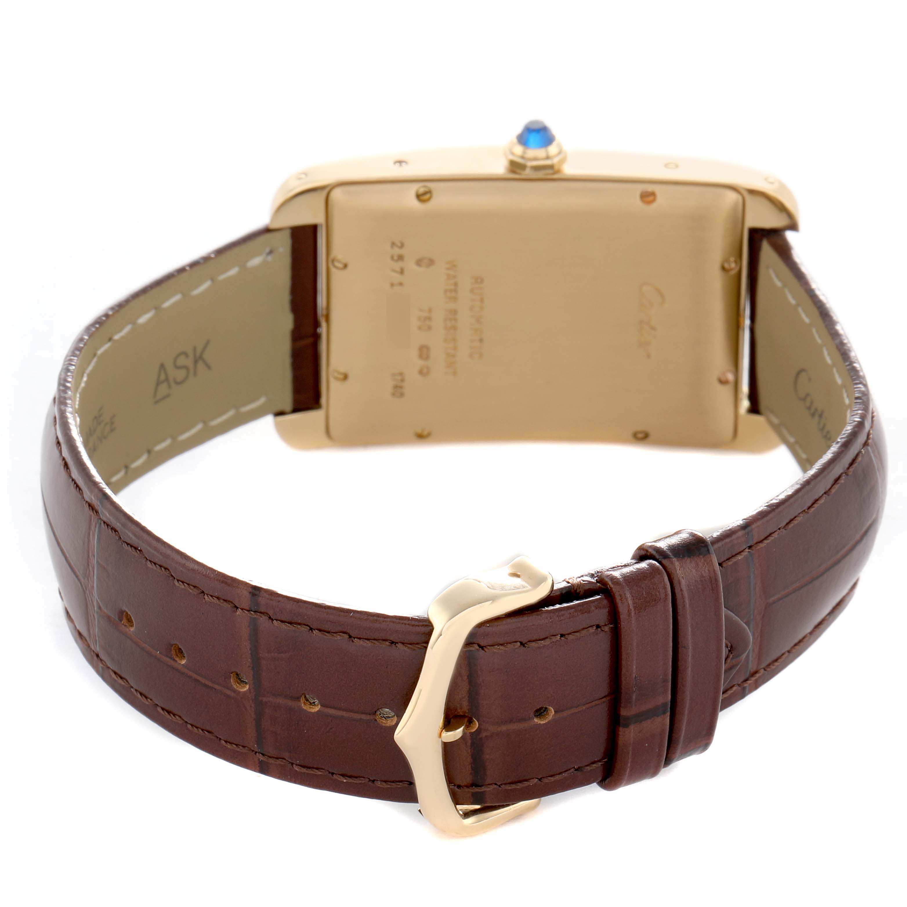 The Cartier Tank Américaine is shown from the back, highlighting its casing, strap, buckle, and crown with a blue topping.