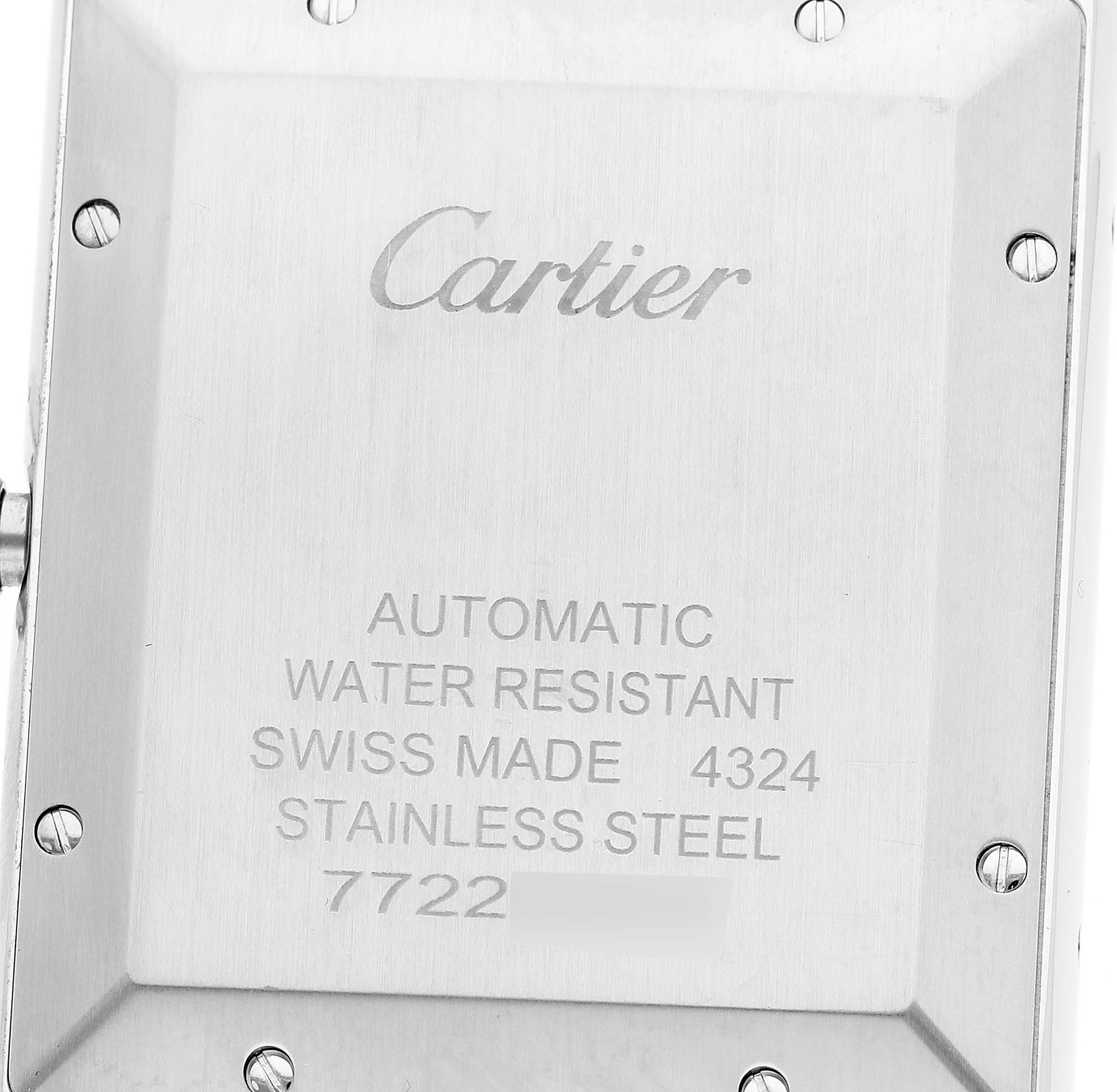 The image shows the back case of a Cartier Tank Must WSTA0053 Men's Stainless Steel Silver Dial watch, displaying engravings and screw details.