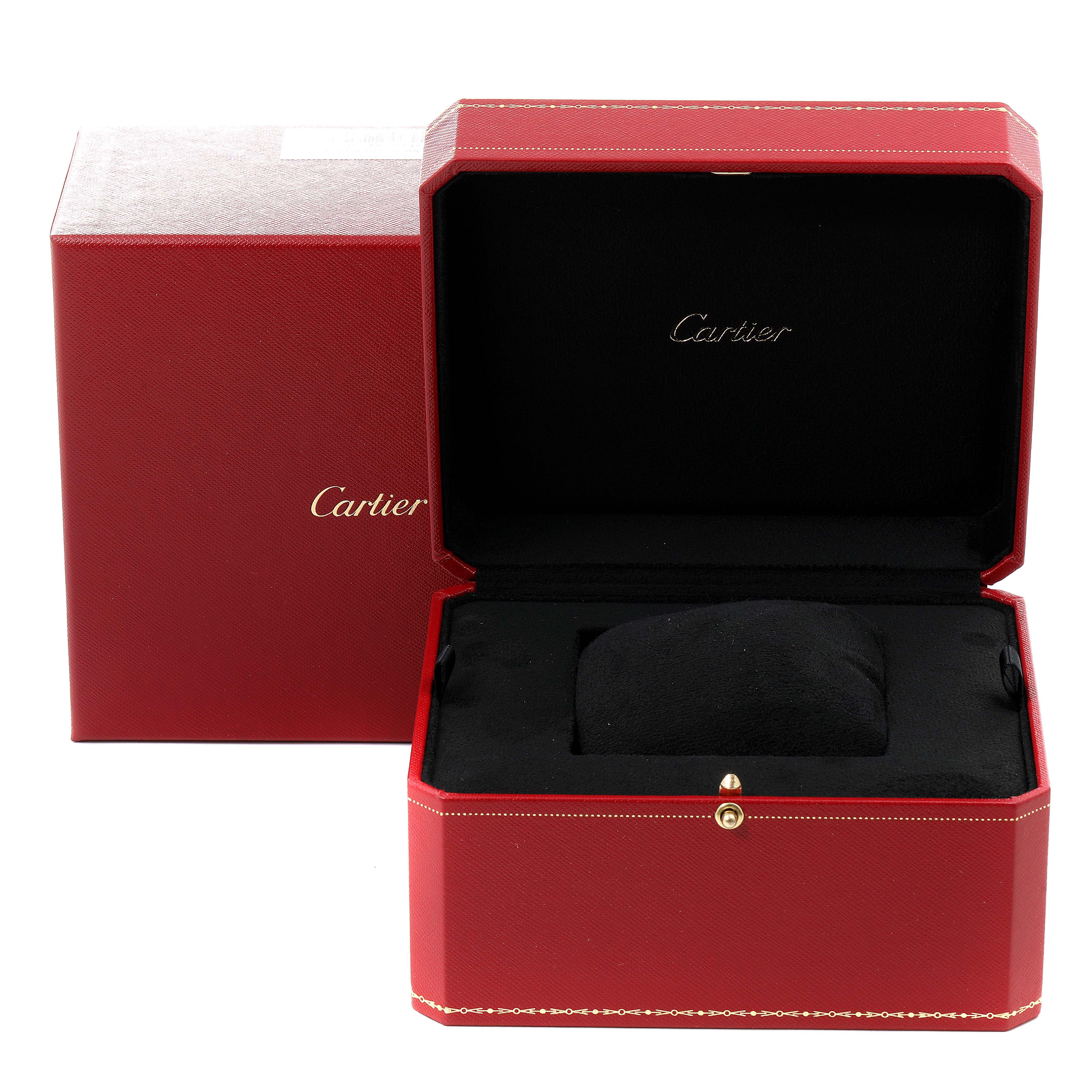 This image shows a red Cartier watch box and outer packaging for the Tortue model, with an open lid and a black cushion inside.