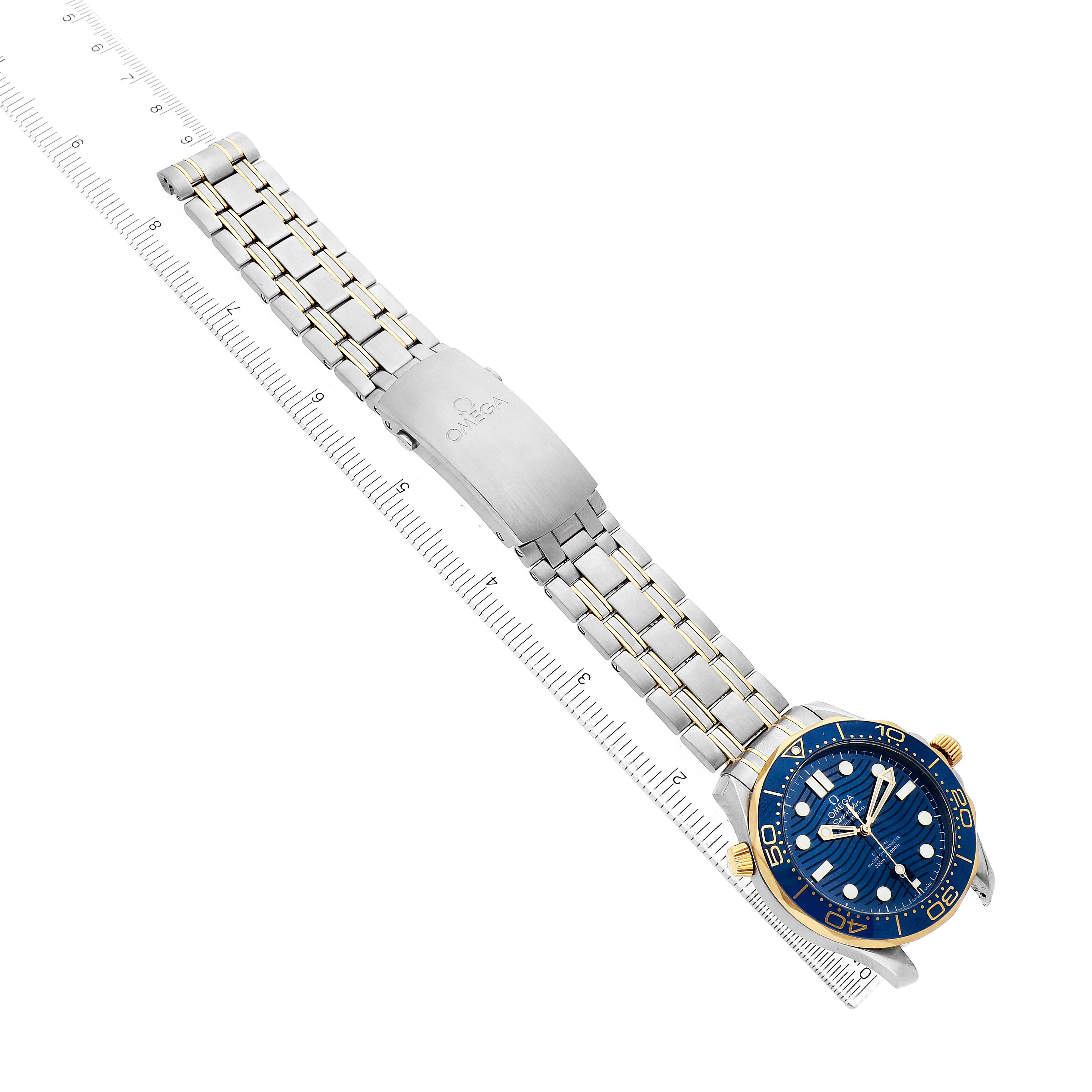 The Omega Seamaster 210.20.42.20.03.001 Men's Steel and Gold (two tone) Blue Dial watch is shown at an angled top-down view, displaying the bracelet, clasp, and blue dial with gold accents.