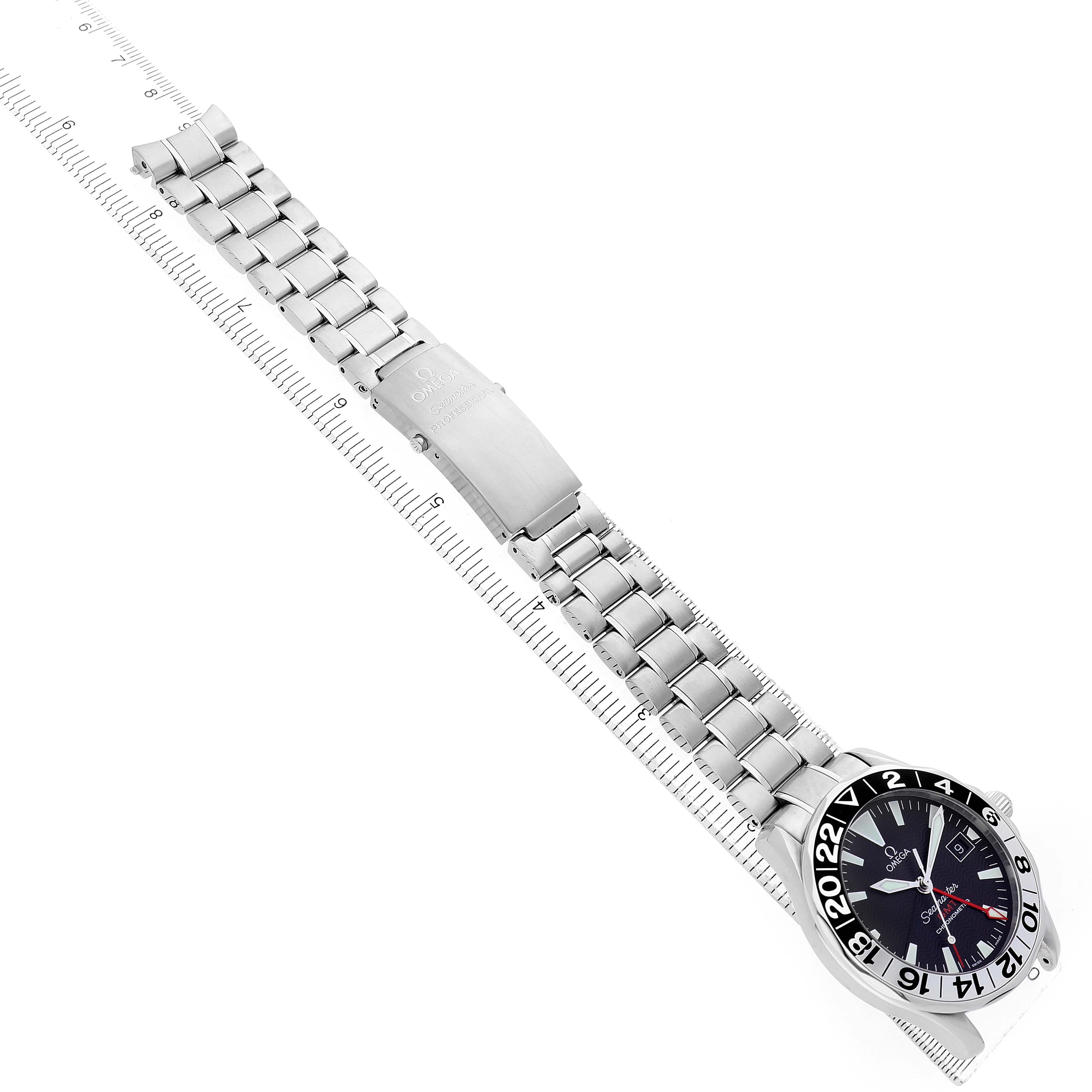 The Omega Seamaster 2536.50.00 Men's Stainless Steel Black Dial watch is shown at an oblique angle, featuring its face, bezel, and entire metal bracelet laid flat next to a ruler.