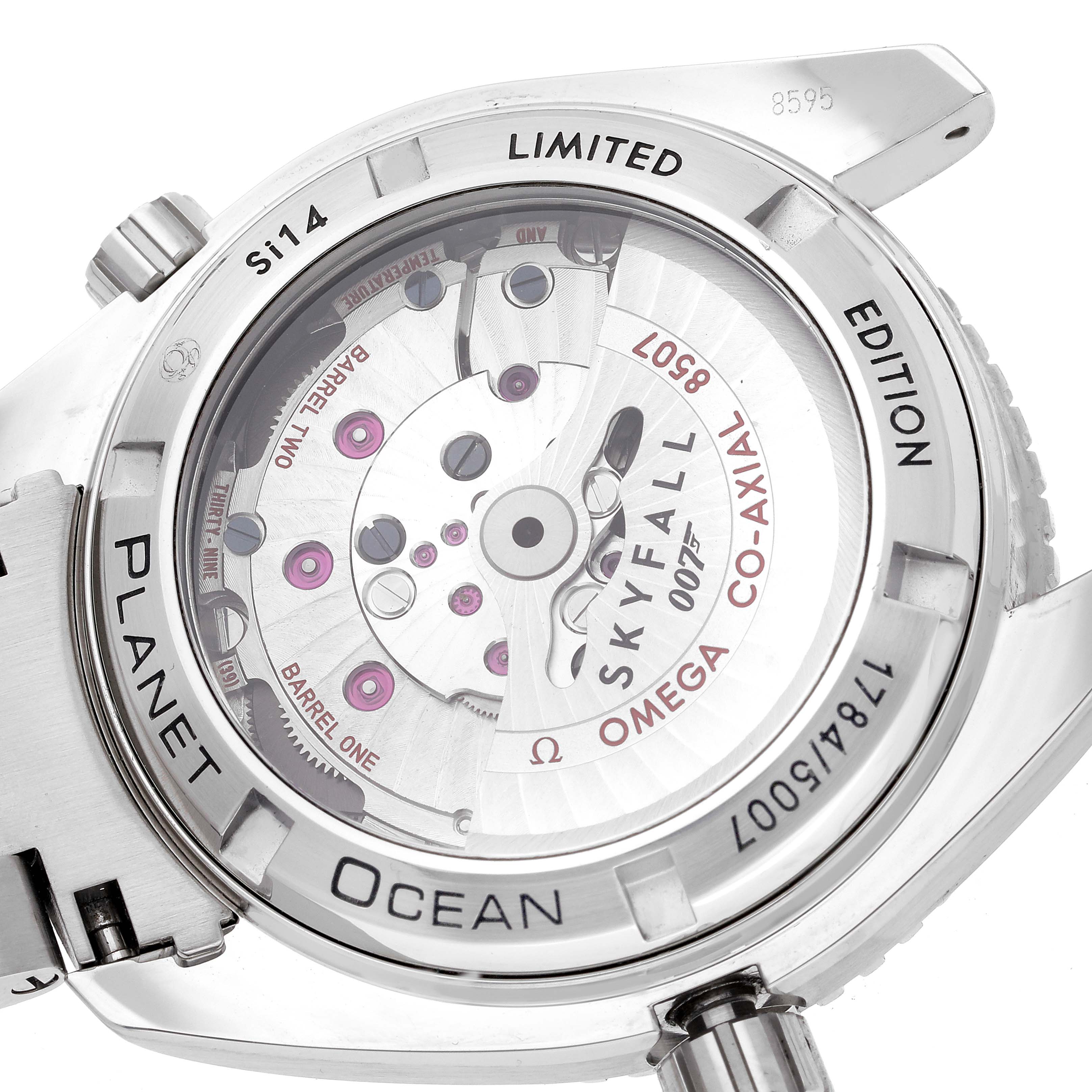 The image shows the back of the Omega Planet Ocean 232.30.42.21.01.004 Men's Stainless Steel Black Dial 232.30.42.21.01.004 Men's Stainless Steel Black Dial Skyfall edition, highlighting the co-axial movement mechanism.