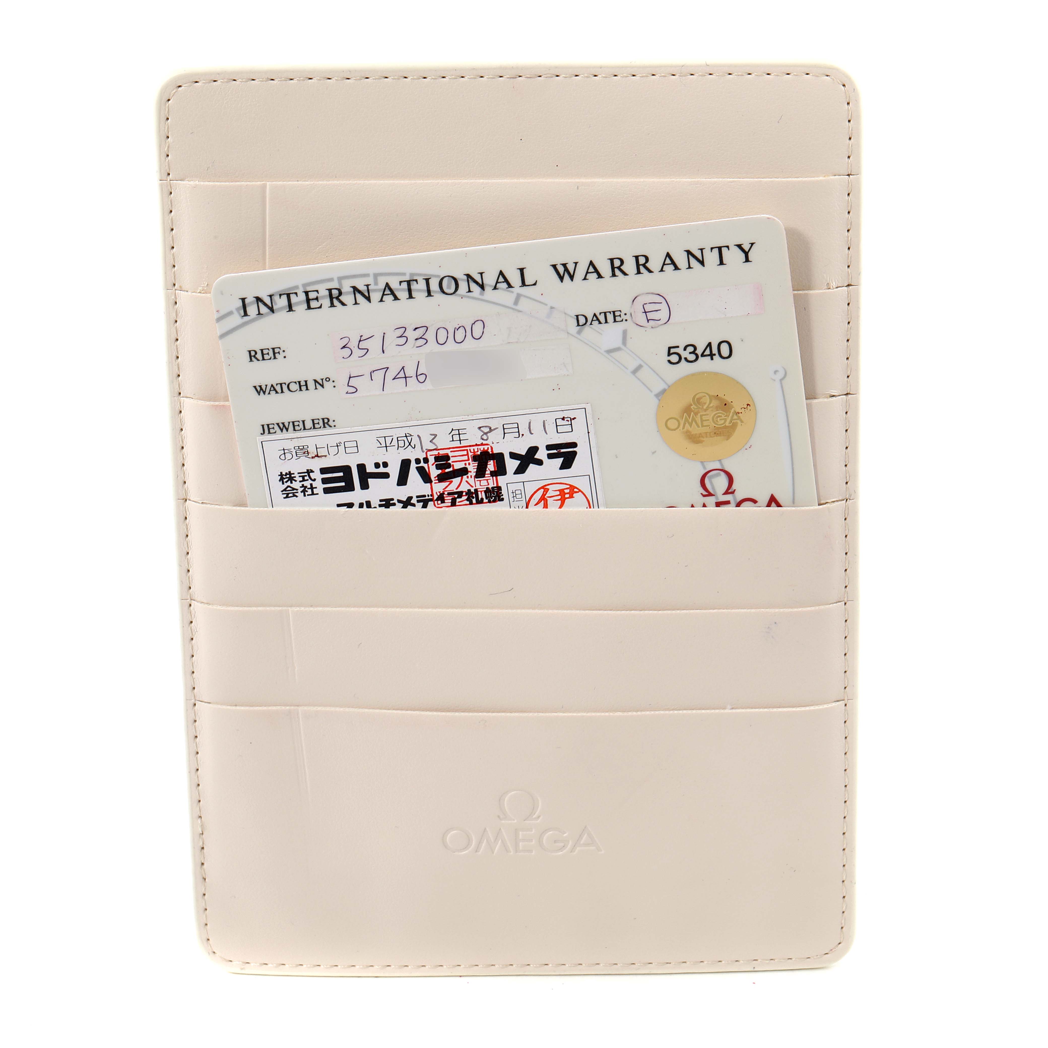 This image shows a white Omega cardholder with an international warranty card for an Omega Speedmaster 3513.30.00 Men
s Stainless Steel Silver Dial 3513.30.00 Men
s Stainless Steel Silver Dial watch inside it.