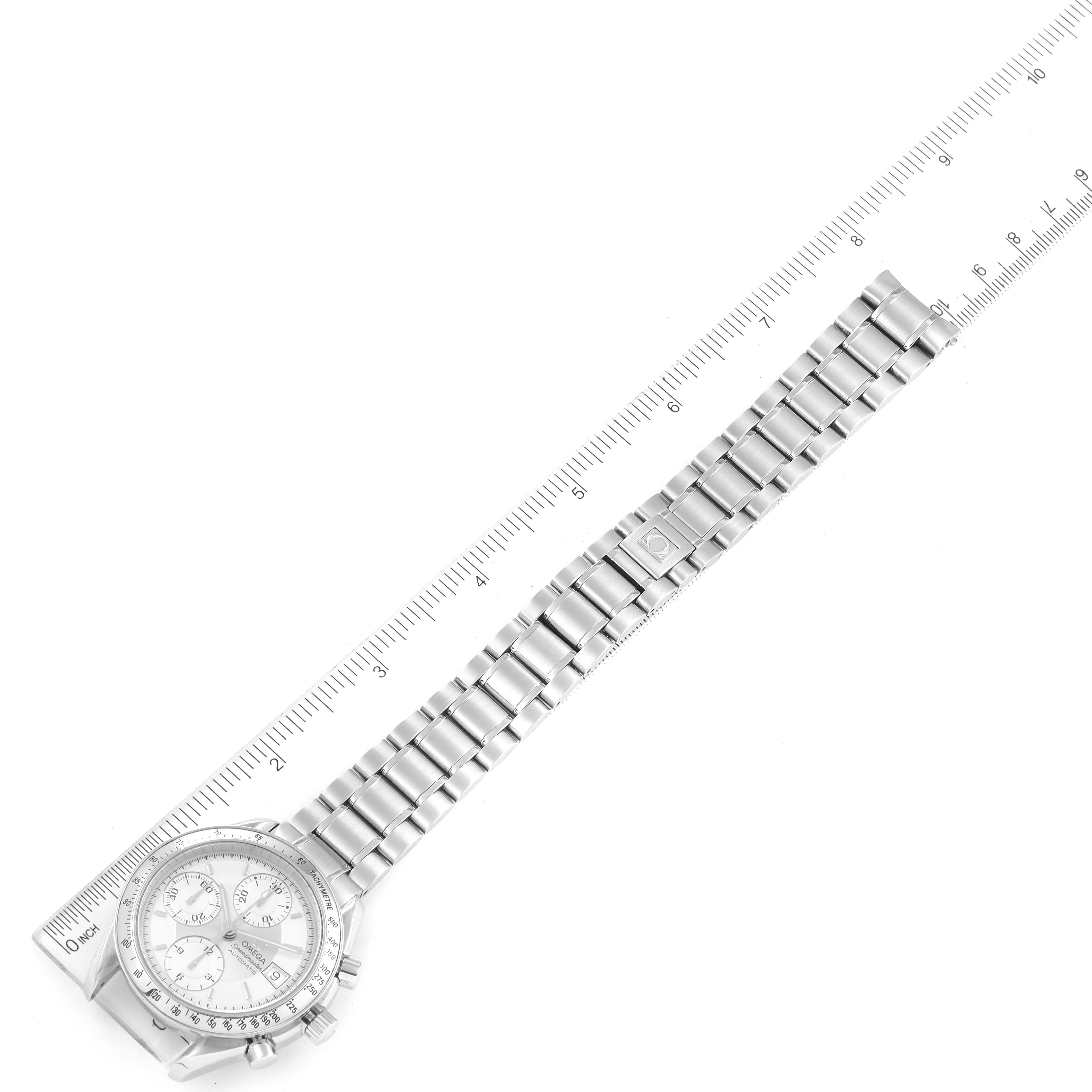 This image shows an Omega Speedmaster 3513.30.00 Men
s Stainless Steel Silver Dial 3513.30.00 Men
s Stainless Steel Silver Dial watch laid flat with its metal bracelet and a ruler for scale.