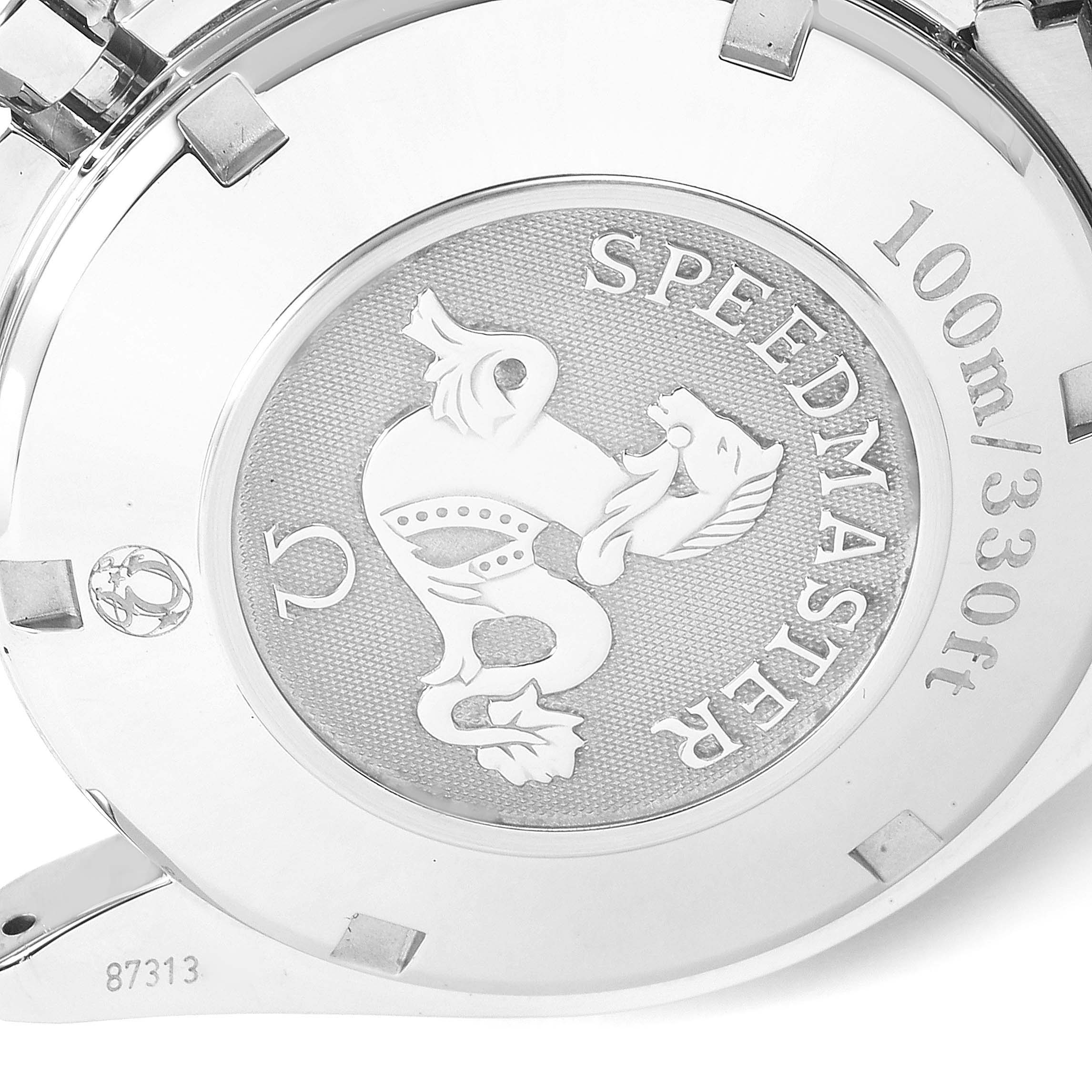 The image shows the back case of an Omega Speedmaster 323.30.40.40.06.001 Men's Stainless Steel Grey Dial 323.30.40.40.06.001 Men's Stainless Steel Grey Dial watch, displaying its emblem, water resistance, and some engravings.