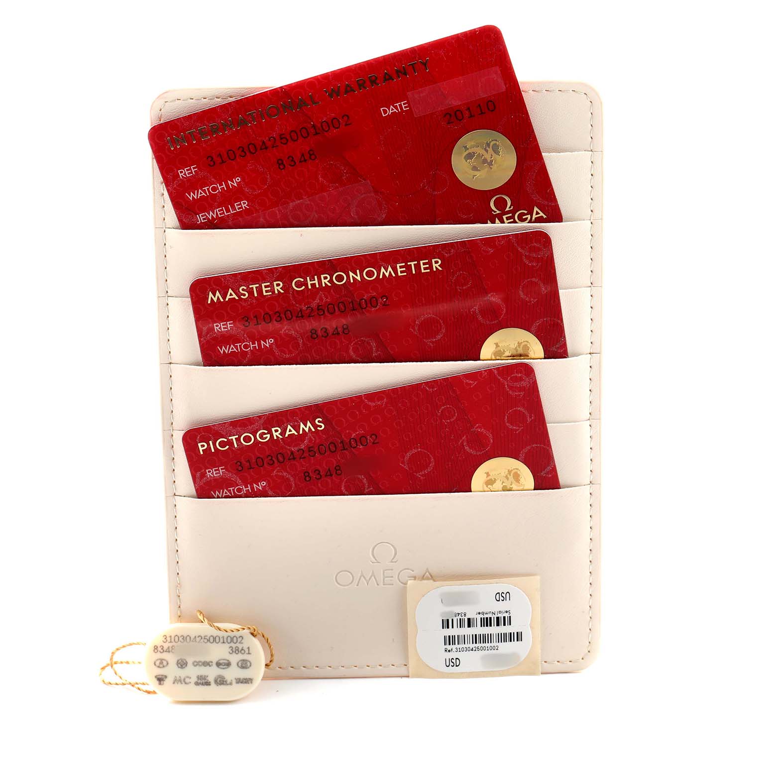 The image shows Omega Speedmaster 310.30.42.50.01.002 Men's Stainless Steel Black Dial documents: International Warranty, Master Chronometer, and Pictograms cards in a cardholder with tags.