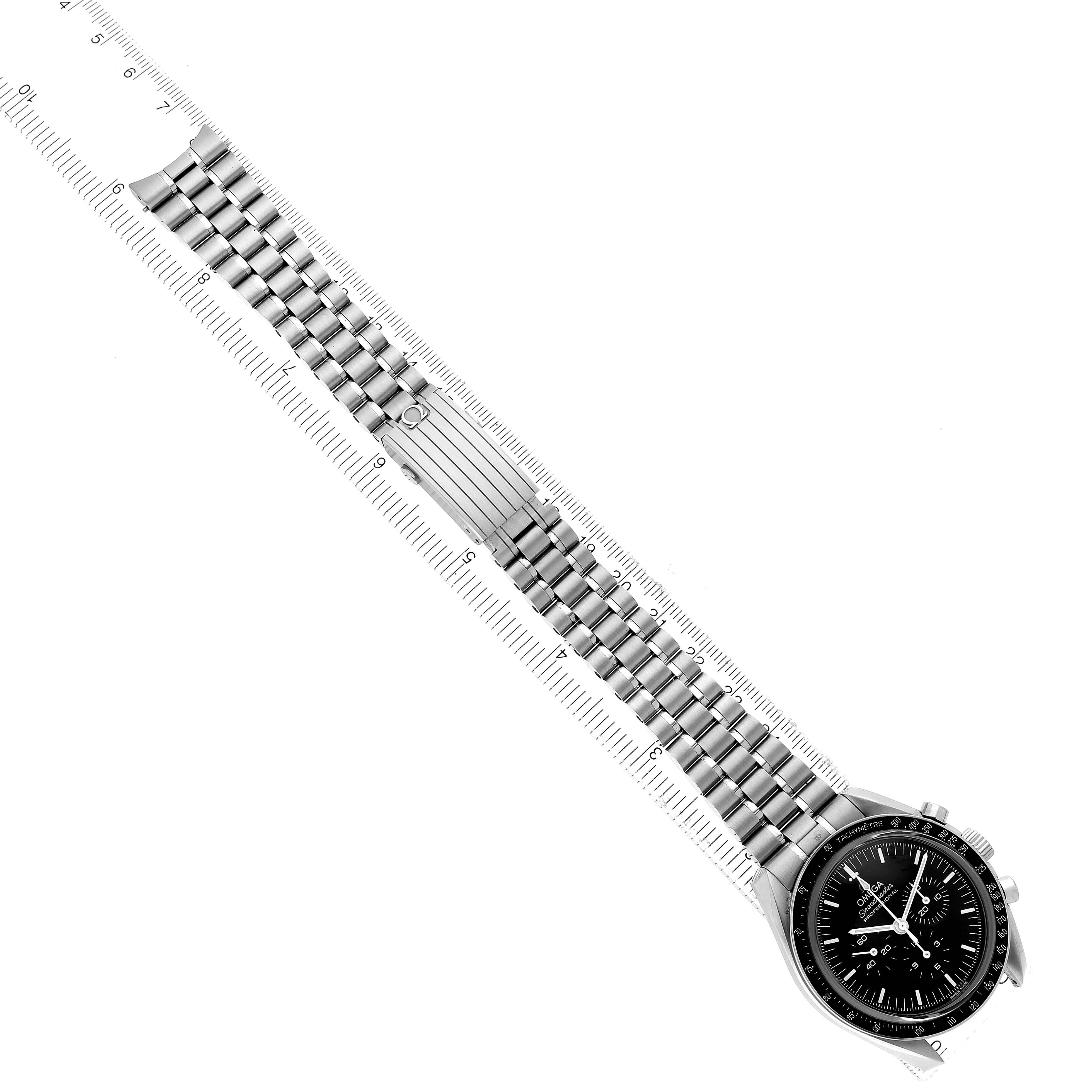 The Omega Speedmaster 310.30.42.50.01.002 Men's Stainless Steel Black Dial watch is shown from a top-down angle, displaying its face and full stainless steel bracelet with a ruler for scale.