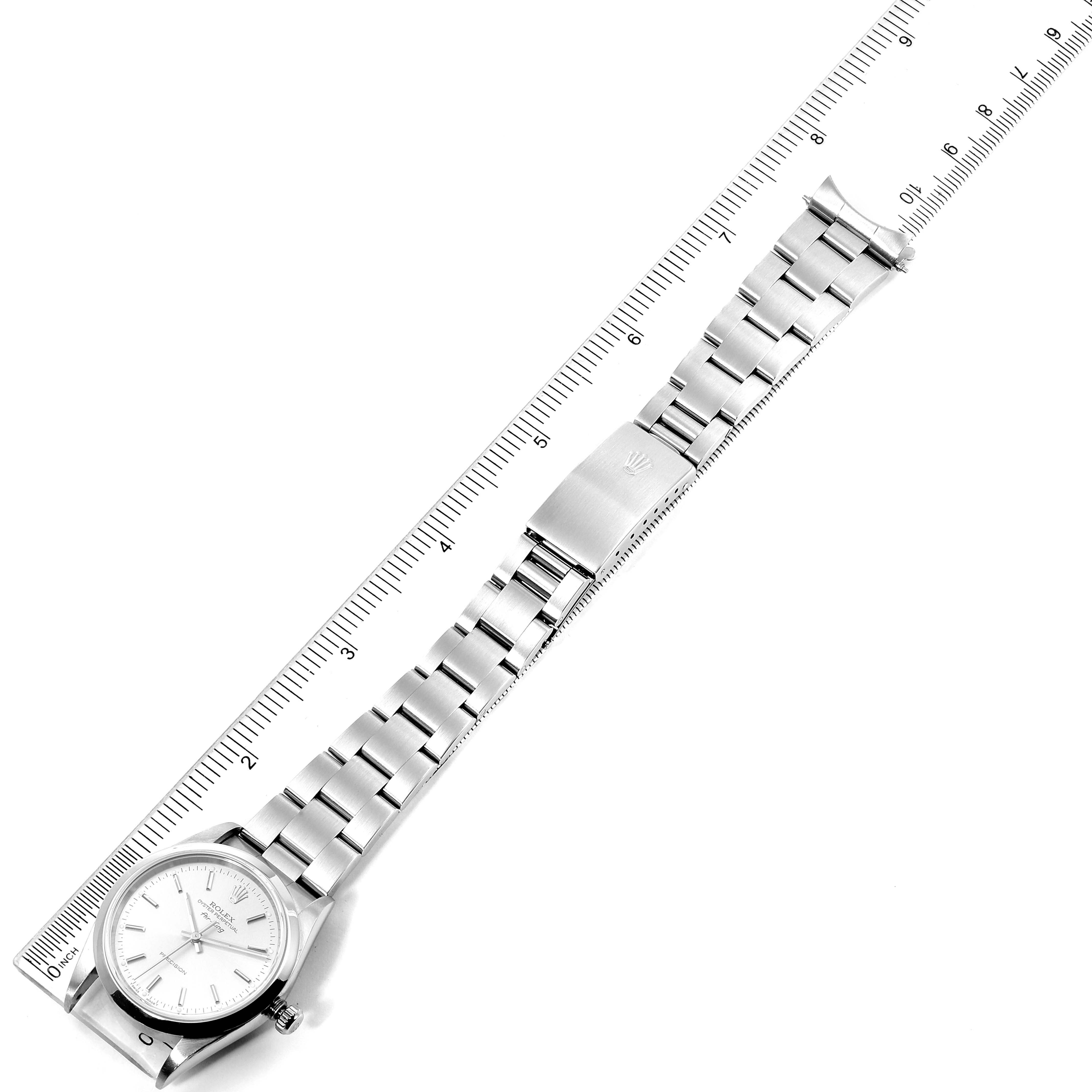 The Rolex Air-King 14000 Men's Stainless Steel Silver Dial 14000 Men's Stainless Steel Silver Dial watch is shown from a top-down angle alongside a measuring ruler, highlighting the face and bracelet.