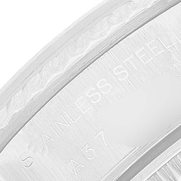 This image shows a close-up view of the casing of a Rolex Datejust 79174 Women's Stainless Steel Silver Dial 79174 Women's Stainless Steel Silver Dial watch, highlighting its engraving details.