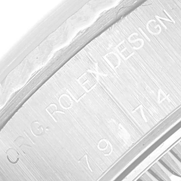 The image shows a close-up of the outer rim of a Rolex Datejust 79174 Women's Stainless Steel Silver Dial 79174 Women's Stainless Steel Silver Dial watch, highlighting the engraved text "ORIG. ROLEX DESIGN."