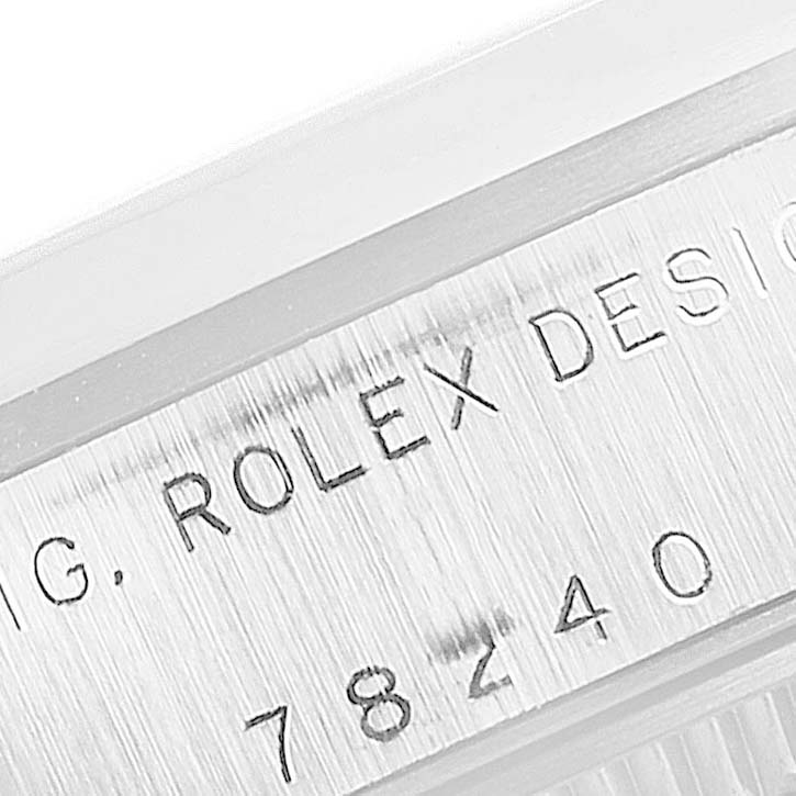 The image shows a close-up view of the case side engraving on a Rolex Mid-Size 78240 Women's Stainless Steel Pink Dial 78240 Women's Stainless Steel Pink Dial model watch, highlighting the serial number and brand.