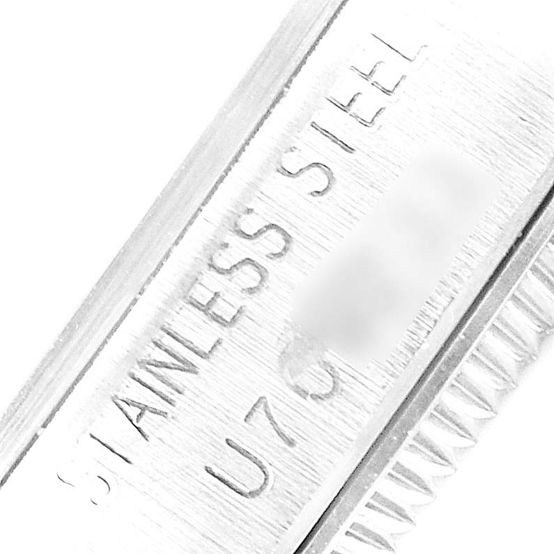 This close-up image shows the side engraving on a stainless steel Mid-Size Rolex watch.