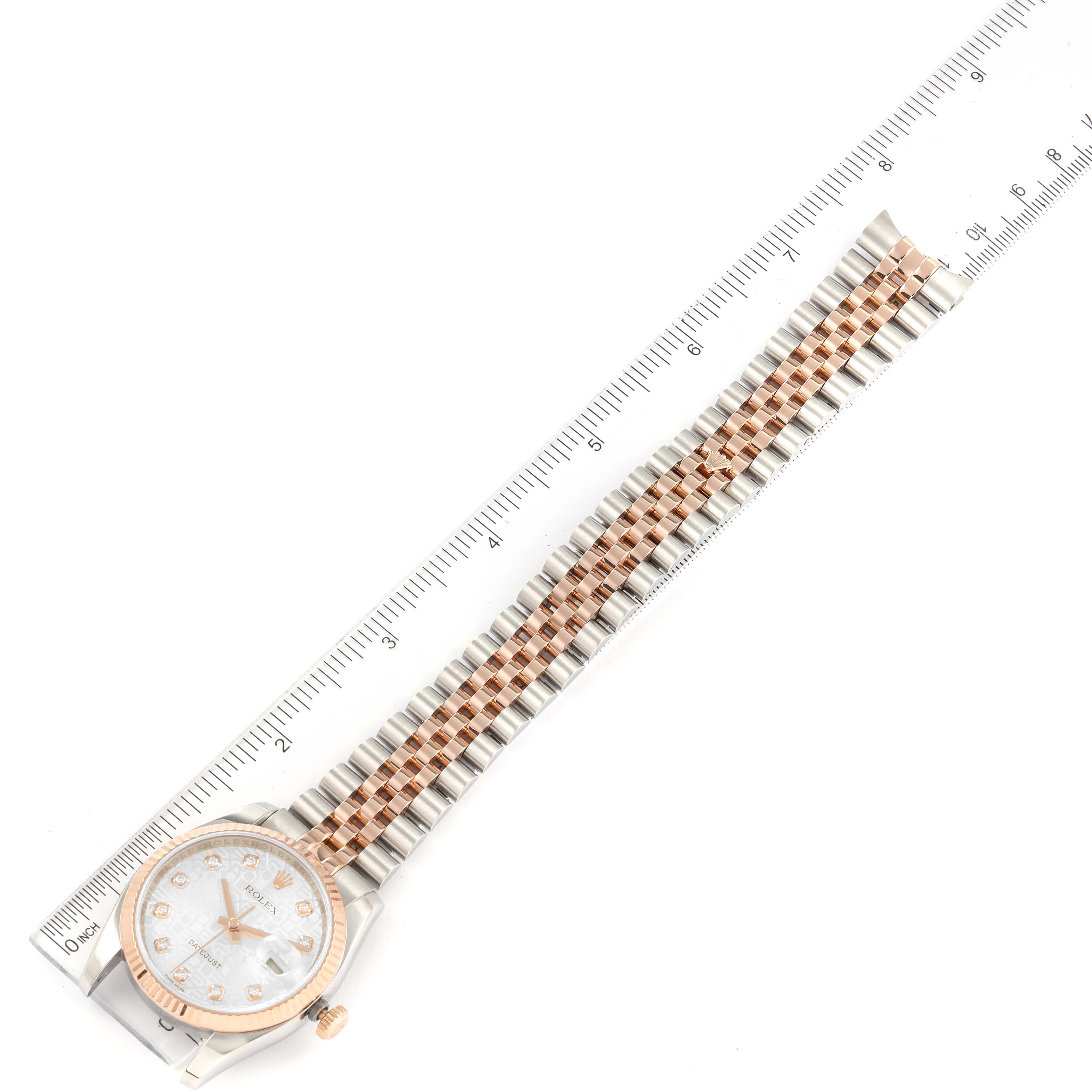 The image shows an overhead view of a Rolex Datejust 116231 Men's Steel and Gold (two tone) Silver Dial 116231 Men's Steel and Gold (two tone) Silver Dial watch, highlighting its face, bezel, and two-tone bracelet, alongside a ruler measuring it.