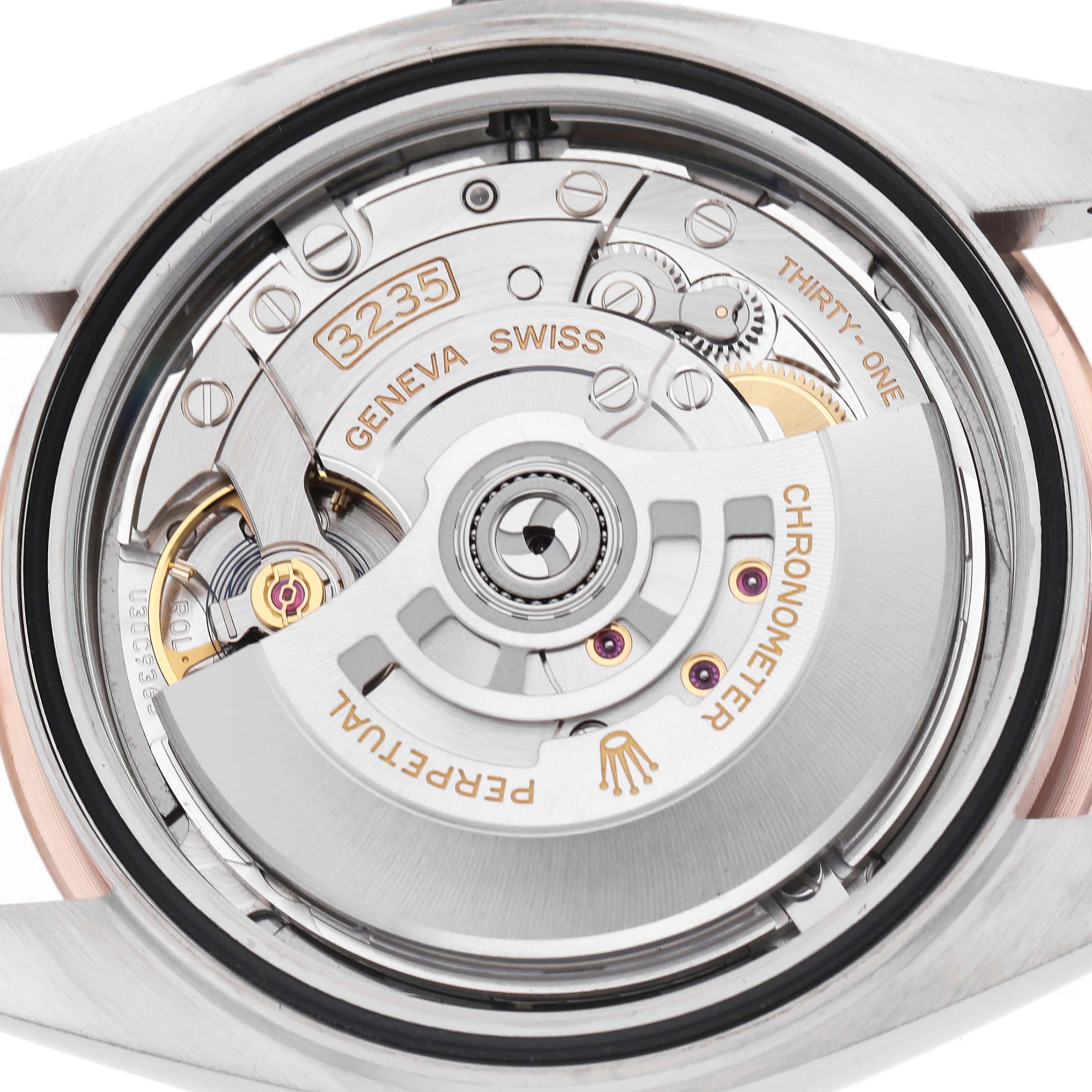 This image shows the internal mechanism of a Rolex Datejust 41 126301 Men's Steel and Gold (two tone) Grey Dial, focusing on the movement from the back.
