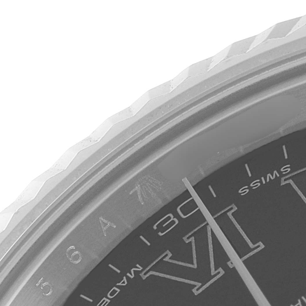 This close-up image of the Rolex Datejust 41 116334 Men
s Stainless Steel Grey Dial 116334 Men
s Stainless Steel Grey Dial shows the edge of the dial with hour markers, part of the bezel, and a portion of the minute hand.