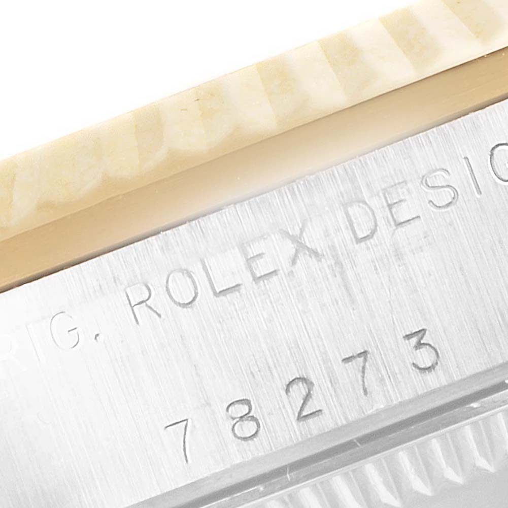 This close-up of a Rolex Mid-Size 78273 Women's Steel and Gold (two tone) Champagne Dial 78273 Women's Steel and Gold (two tone) Champagne Dial model shows part of the bezel and the engraved watch model number "78273."