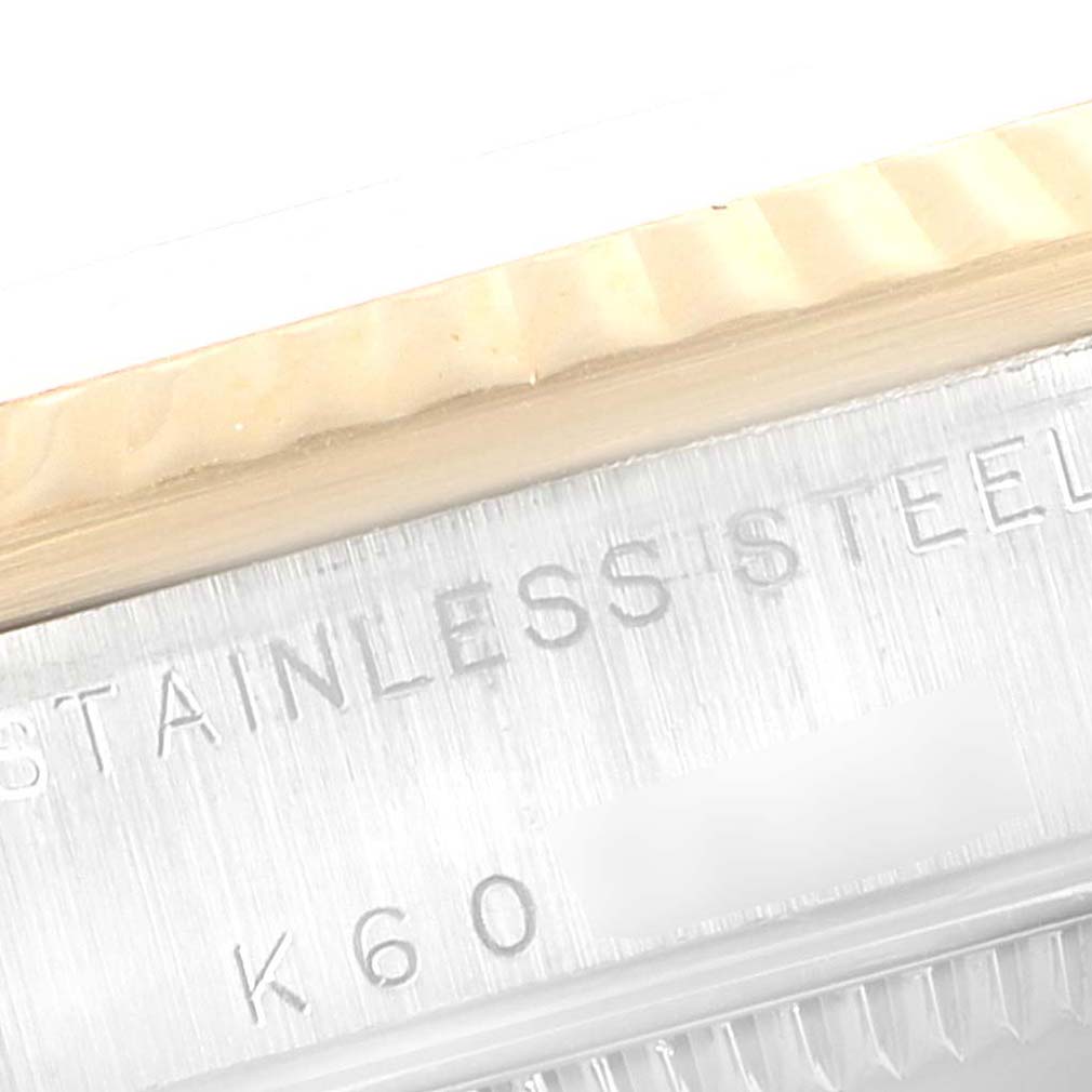 This close-up shows the "STAINLESS STEEL" engraving on the case of a Rolex Mid-Size 78273 Women's Steel and Gold (two tone) Champagne Dial 78273 Women's Steel and Gold (two tone) Champagne Dial watch.