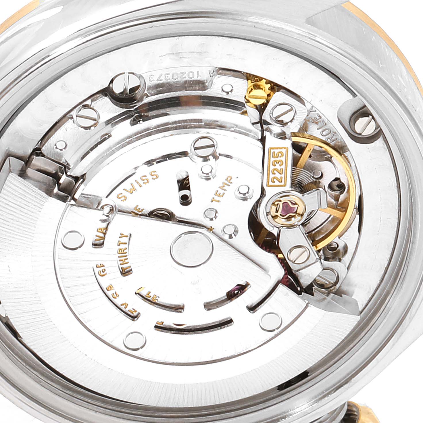 The image shows the inner mechanical movement from the back of a Mid-Size Rolex watch, highlighting gears and components.