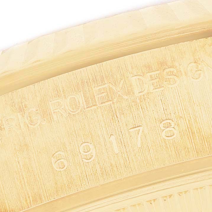 The image shows an angled close-up of the inner case with engraved details of a Rolex President 69178 Women's Yellow Gold Mother of Pearl Dial watch.