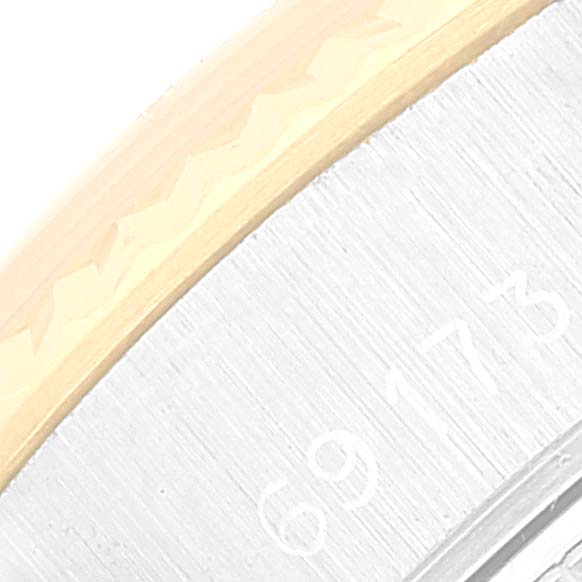 This close-up image of a Rolex Datejust 69173 Women's Steel and Gold (two tone) Champagne Dial 69173 Women's Steel and Gold (two tone) Champagne Dial watch shows a portion of the bezel and the outer rim of the case with the model number.