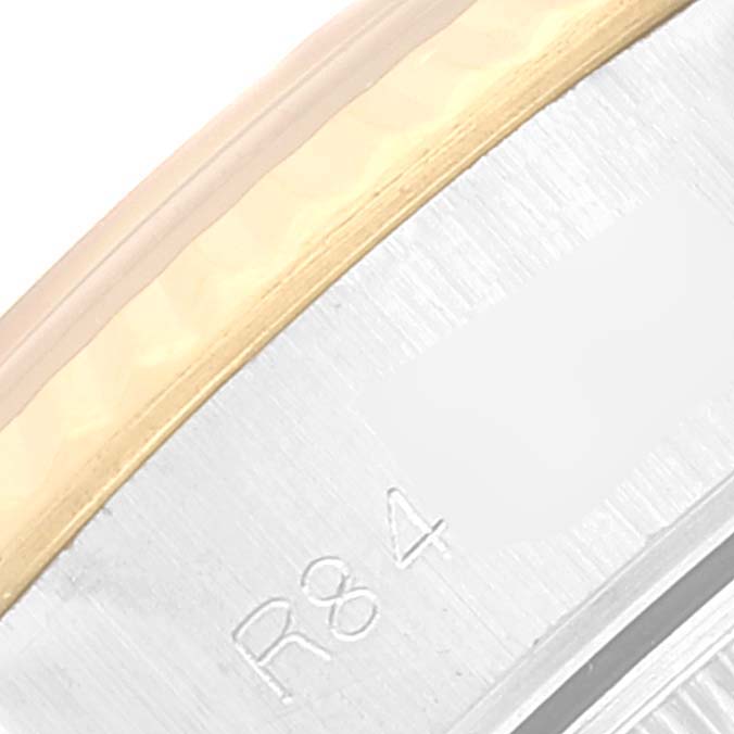 This image shows a close-up angle of the bezel and part of the case back of a Rolex Datejust 69173 Women's Steel and Gold (two tone) Champagne Dial 69173 Women's Steel and Gold (two tone) Champagne Dial watch.