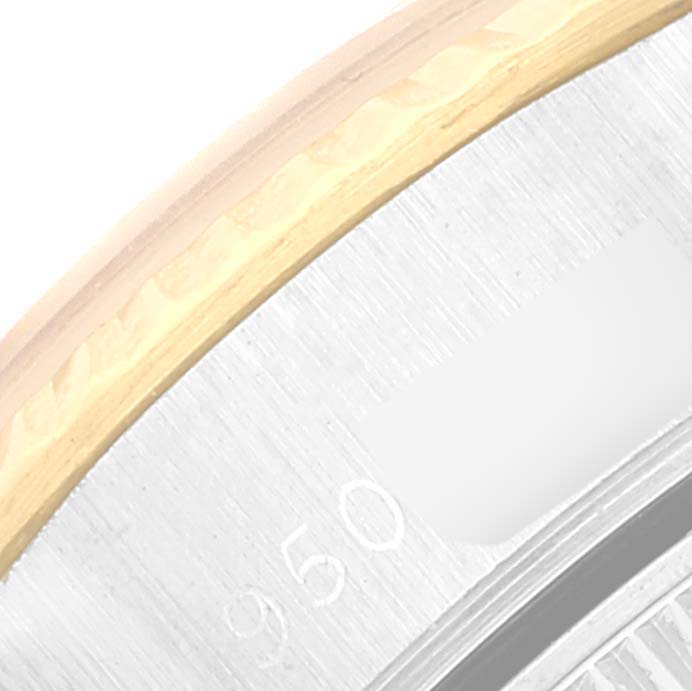 The image shows a close-up of the edge and side of a Rolex Datejust 69173 Women's Steel and Gold (two tone) Champagne Dial 69173 Women's Steel and Gold (two tone) Champagne Dial watch case, displaying the metal texture and engravings.