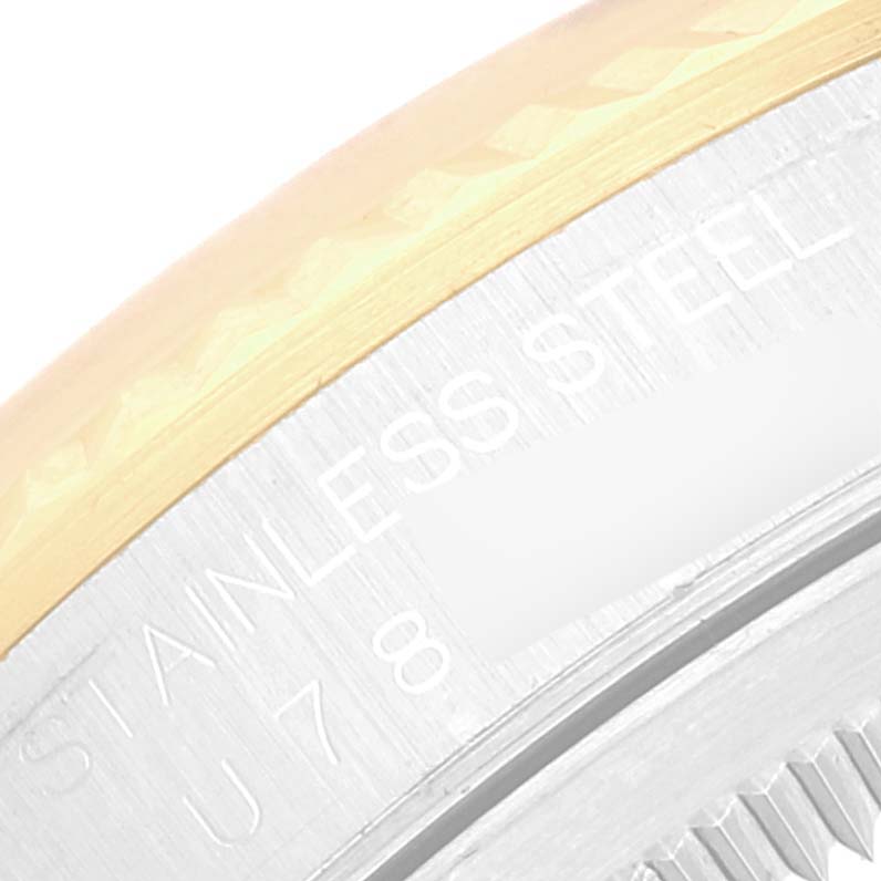 Close-up shot of the Rolex Datejust 16233 Men's Steel and Gold (two tone) Silver Dial 16233 Men's Steel and Gold (two tone) Silver Dial watch, focusing on the side view of the bezel and engraved words on the case back.