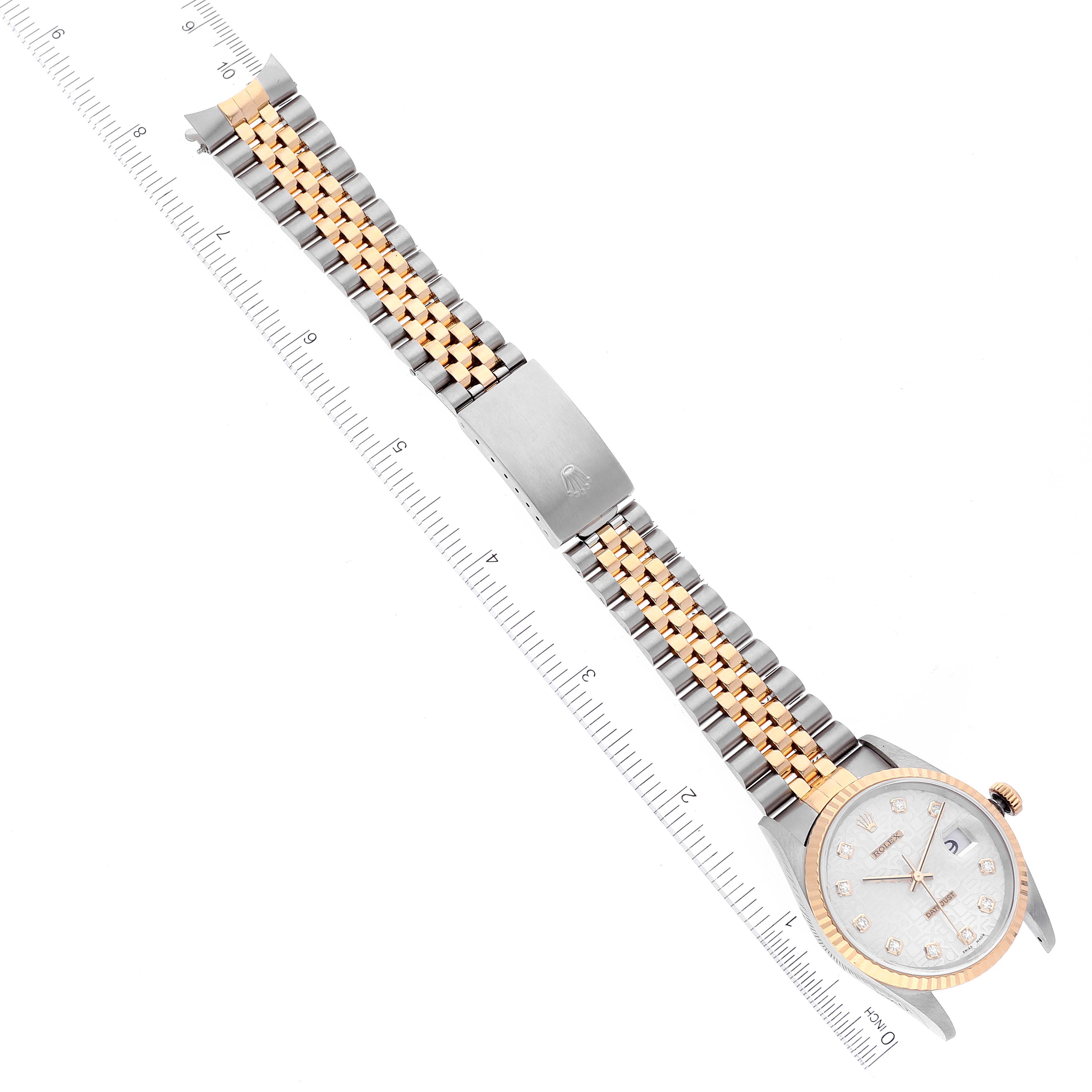 This image shows a top-down view of a Rolex Datejust 16233 Men's Steel and Gold (two tone) Silver Dial 16233 Men's Steel and Gold (two tone) Silver Dial watch, highlighting the face, bezel, and two-tone bracelet with a ruler for scale.