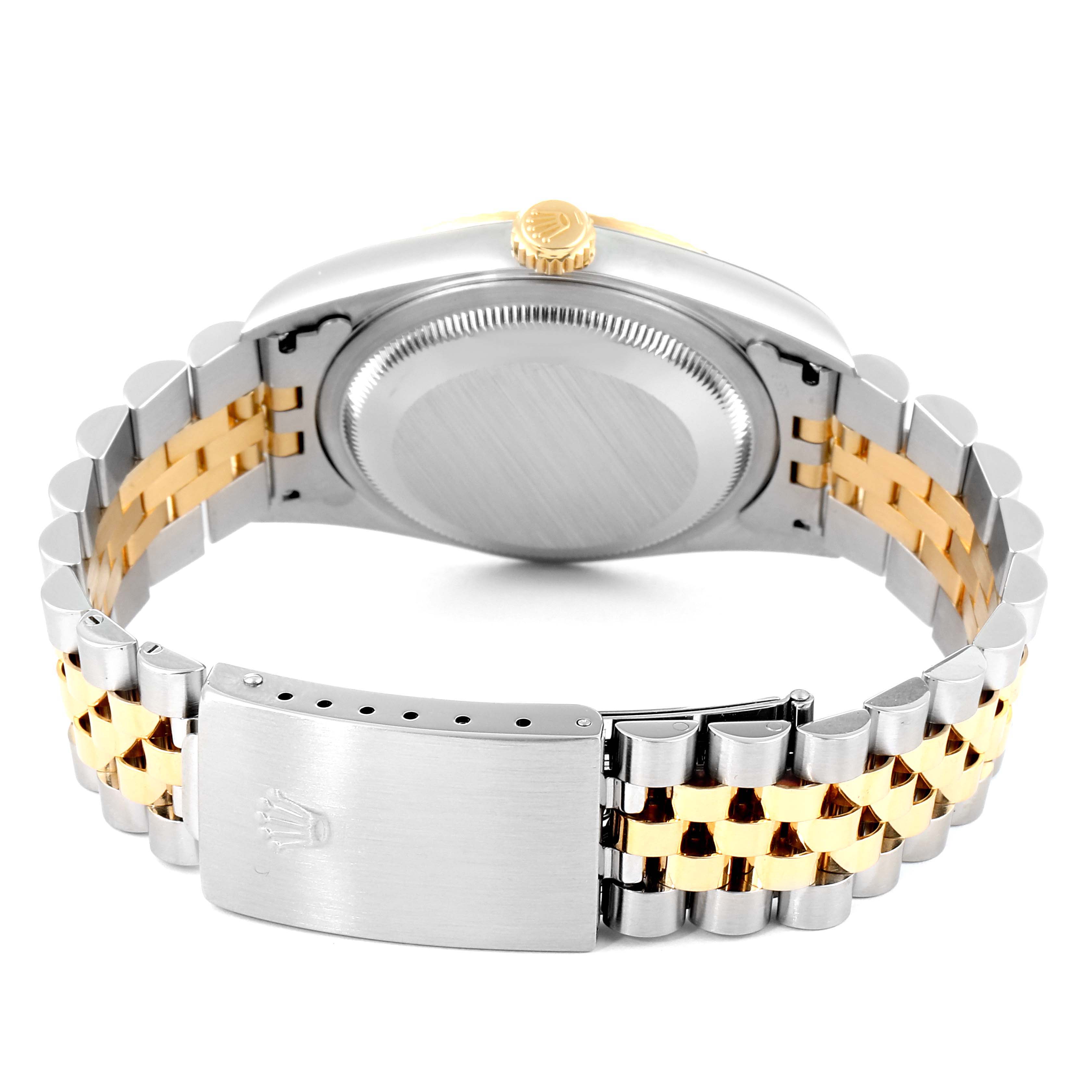 This image shows the back case, crown, and bracelet clasp of a Rolex Datejust 16233 Men's Steel and Gold (two tone) Silver Dial 16233 Men's Steel and Gold (two tone) Silver Dial model watch.