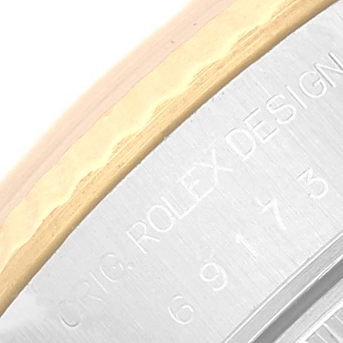 This is a close-up of the Datejust model by Rolex, showing the edge of the bezel and the engraved text on the side.