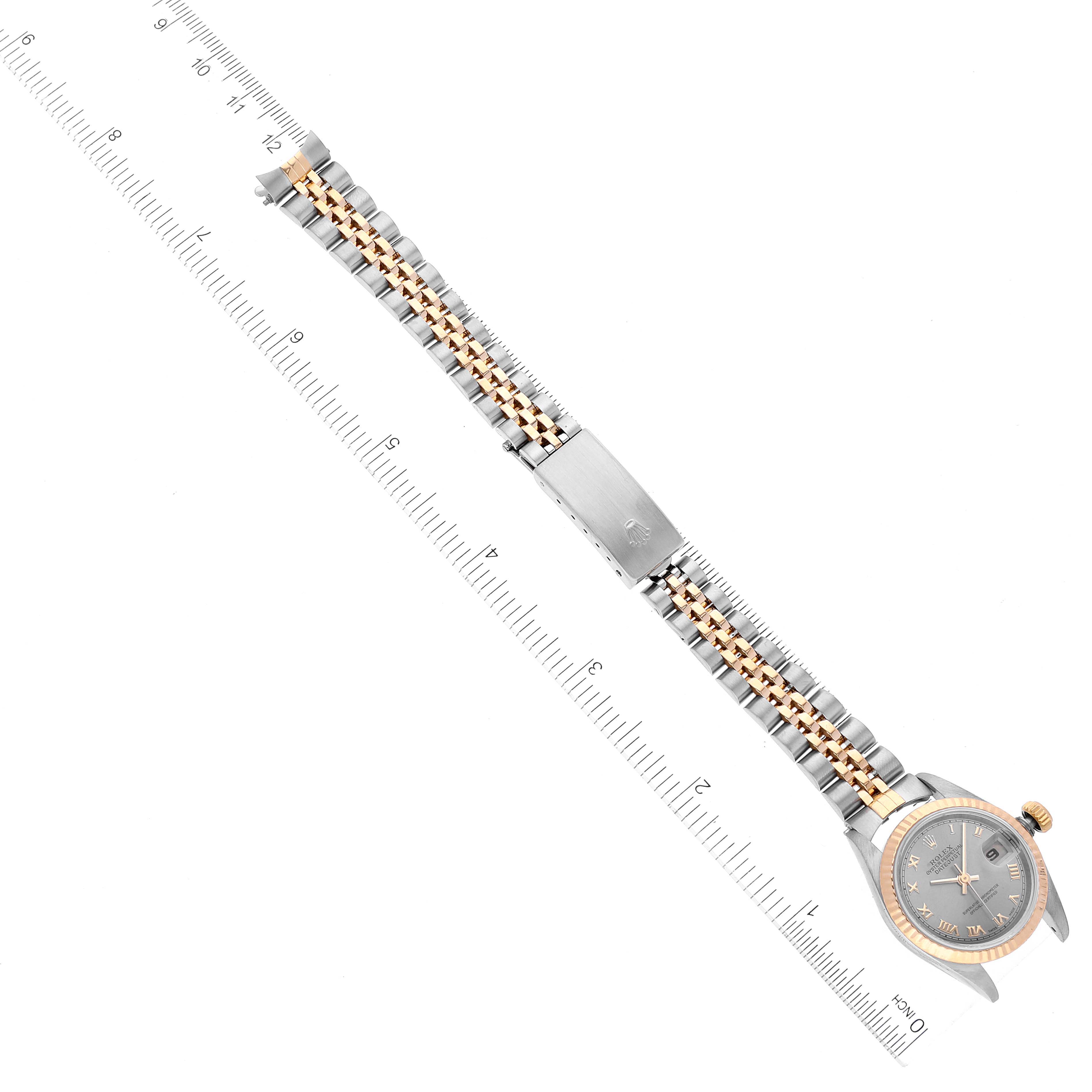 The image shows an overhead view of a Rolex Datejust 69173 Women's Steel and Gold (two tone) Grey Dial 69173 Women's Steel and Gold (two tone) Grey Dial watch and its entire bracelet laid out alongside a ruler for scale.
