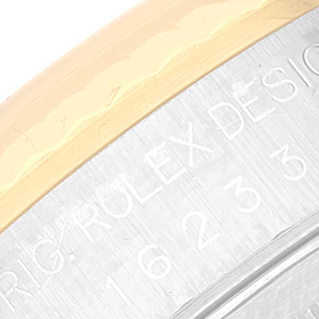 The image shows a close-up of the Rolex Datejust 16233 Men's Steel and Gold (two tone) White Dial 16233 Men's Steel and Gold (two tone) White Dial model's bezel edge and part of its engraved design.