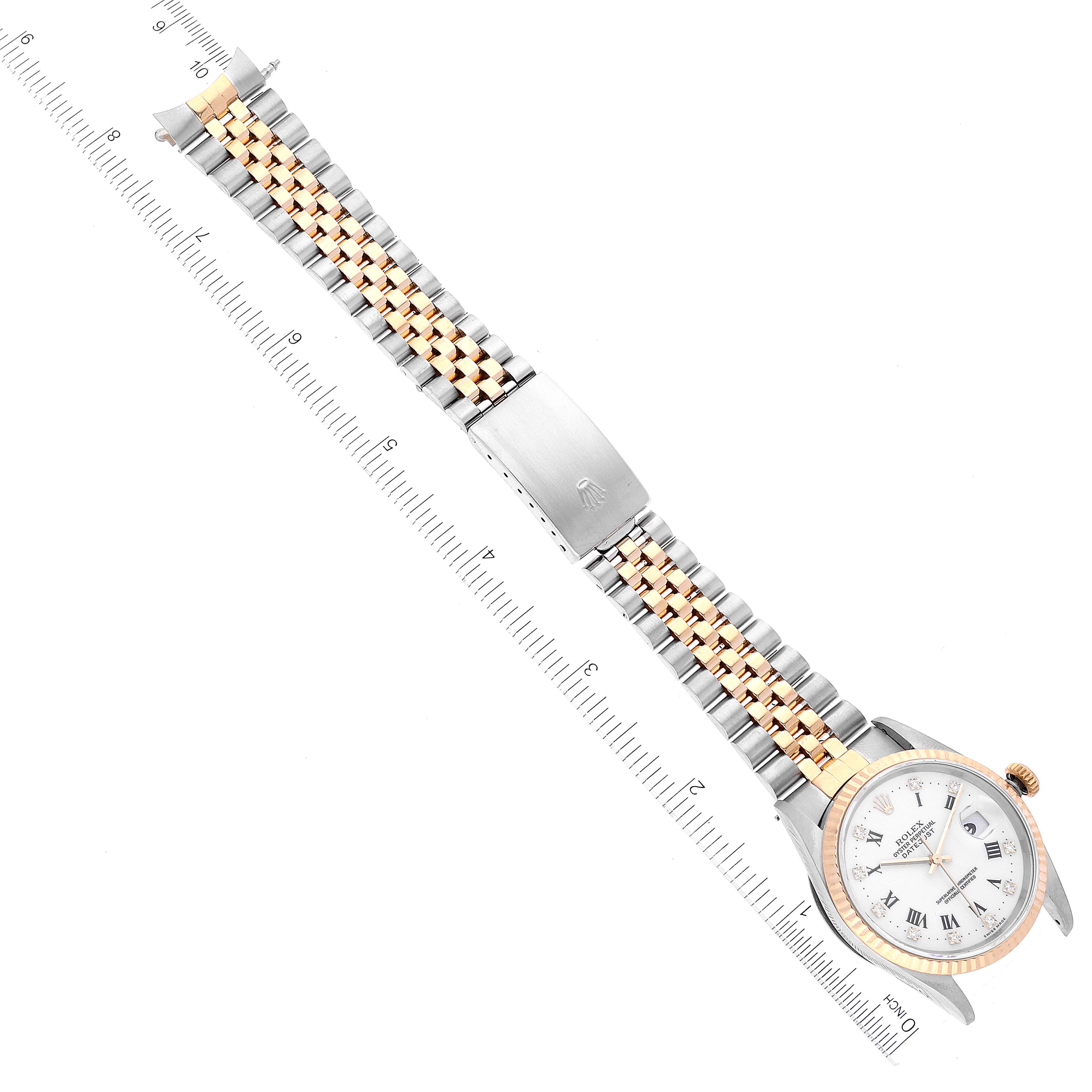 The image shows a Rolex Datejust 16233 Men's Steel and Gold (two tone) White Dial 16233 Men's Steel and Gold (two tone) White Dial watch laid flat with its two-tone Jubilee bracelet extended and a ruler next to it for measurement.