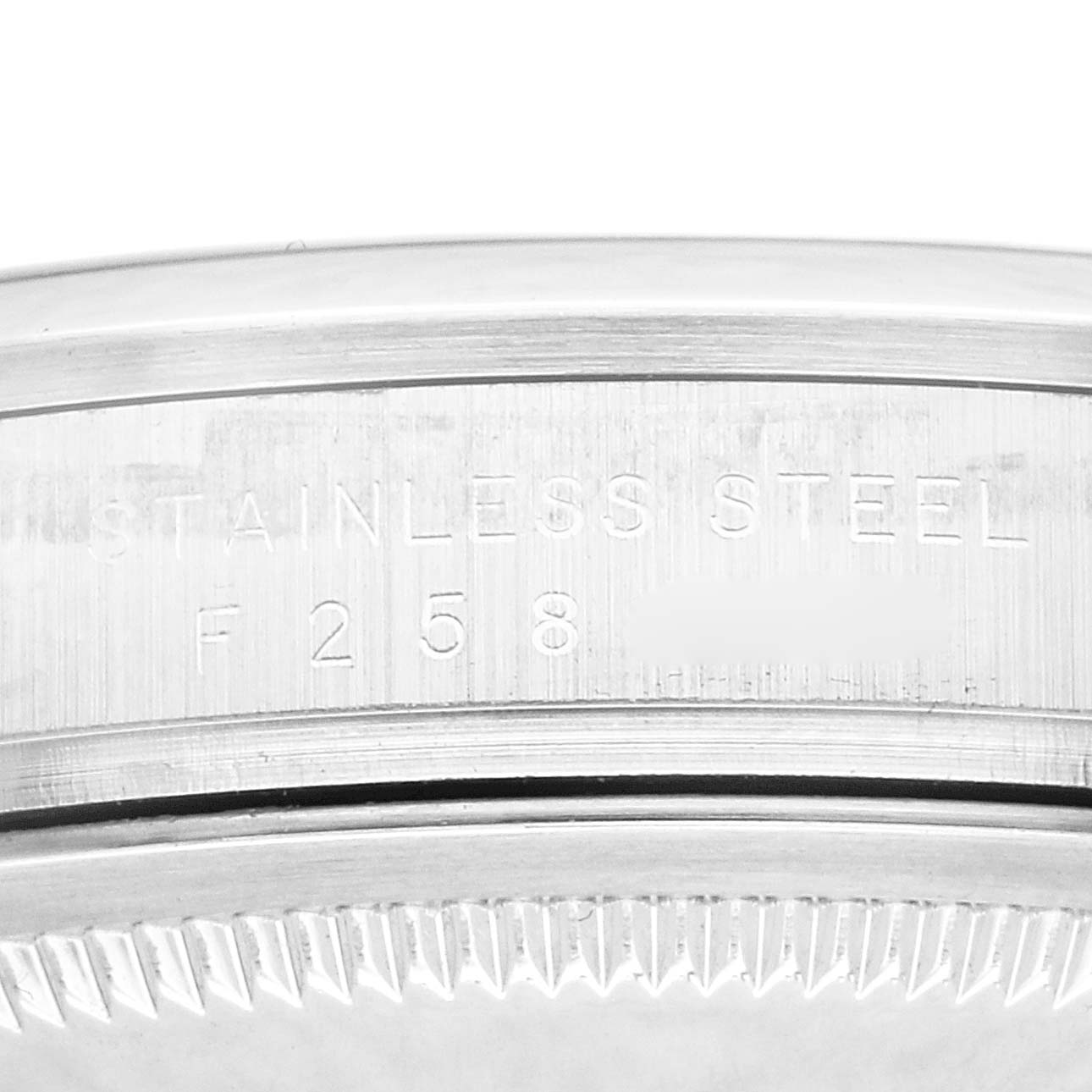 The image shows a close-up of the edge and serial number engraving on a stainless steel case back of a Rolex Explorer 114270 Men
s Stainless Steel Black Dial 114270 Men
s Stainless Steel Black Dial watch.