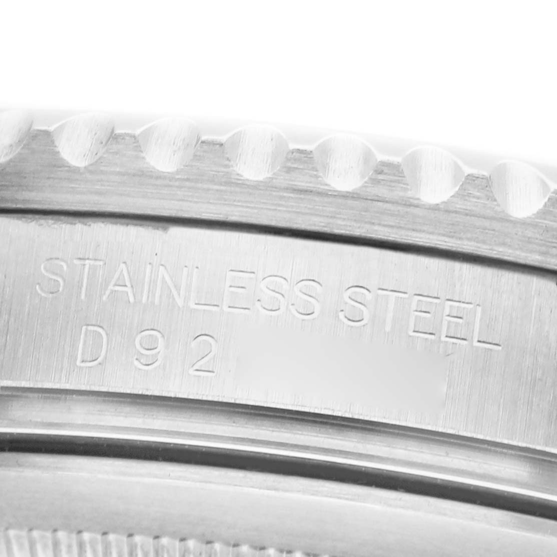 The image shows a close-up of the side of a Rolex GMT-Master 16710 Men's Stainless Steel Black Dial watch, highlighting the stainless steel label and serial engraving.