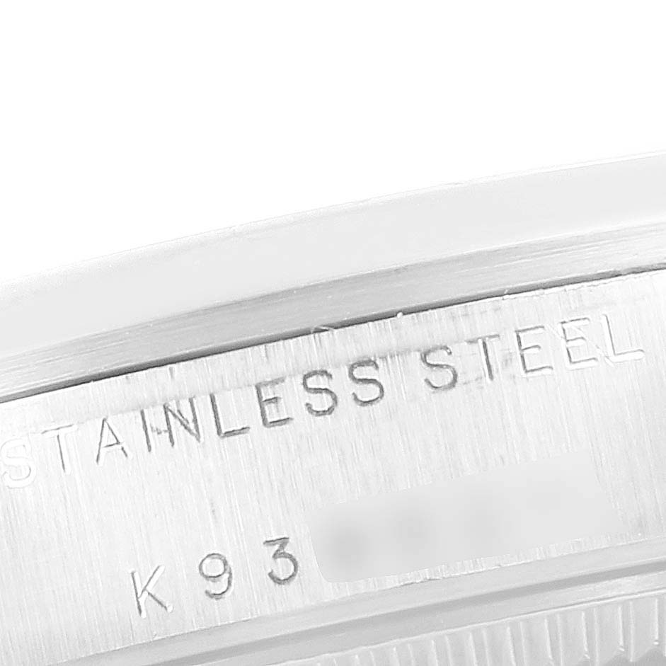 This image shows a close-up of the case back edge detailing on a Mid-Size Rolex watch, highlighting the "STAINLESS STEEL" engraving.
