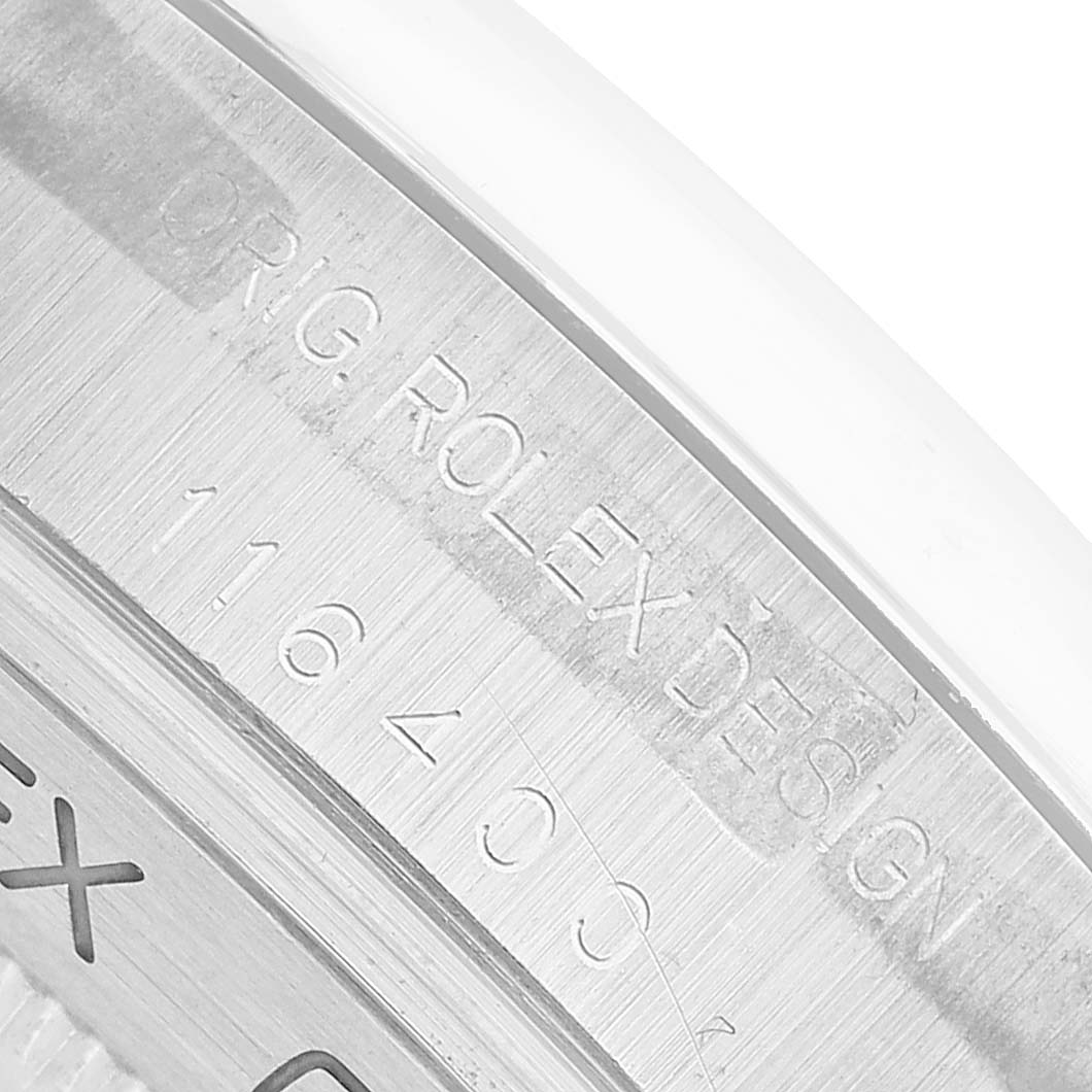 The image shows a close-up angle of the inner bezel with "Orig. Rolex Design" and a model number from the Rolex Milgauss 116400 Men's Stainless Steel Black Dial.