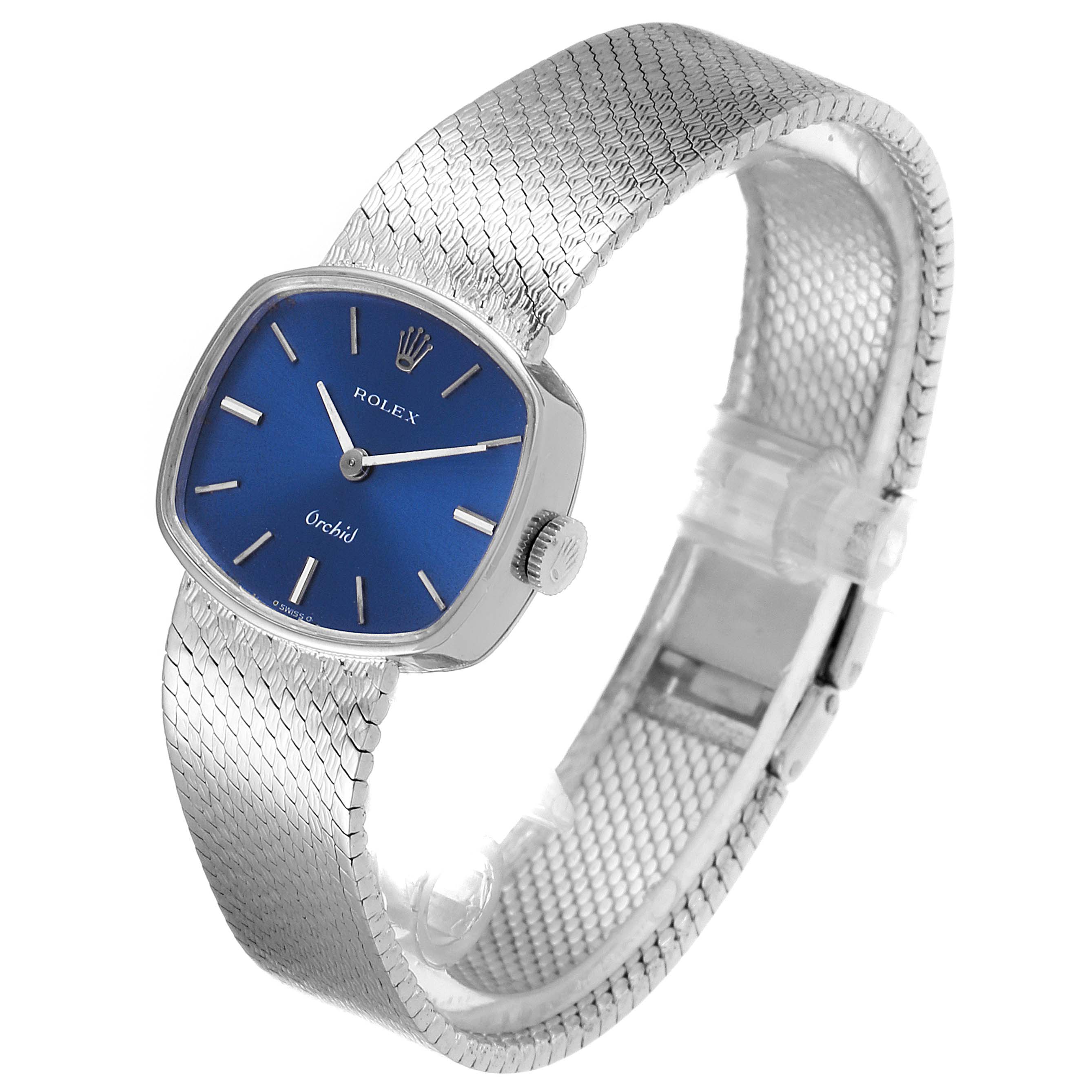 The Rolex Cocktail 2673 Women's White Gold Blue Dial 2673 Women's White Gold Blue Dial model watch is shown at an angle displaying the blue dial, silver hands, and textured silver bracelet.