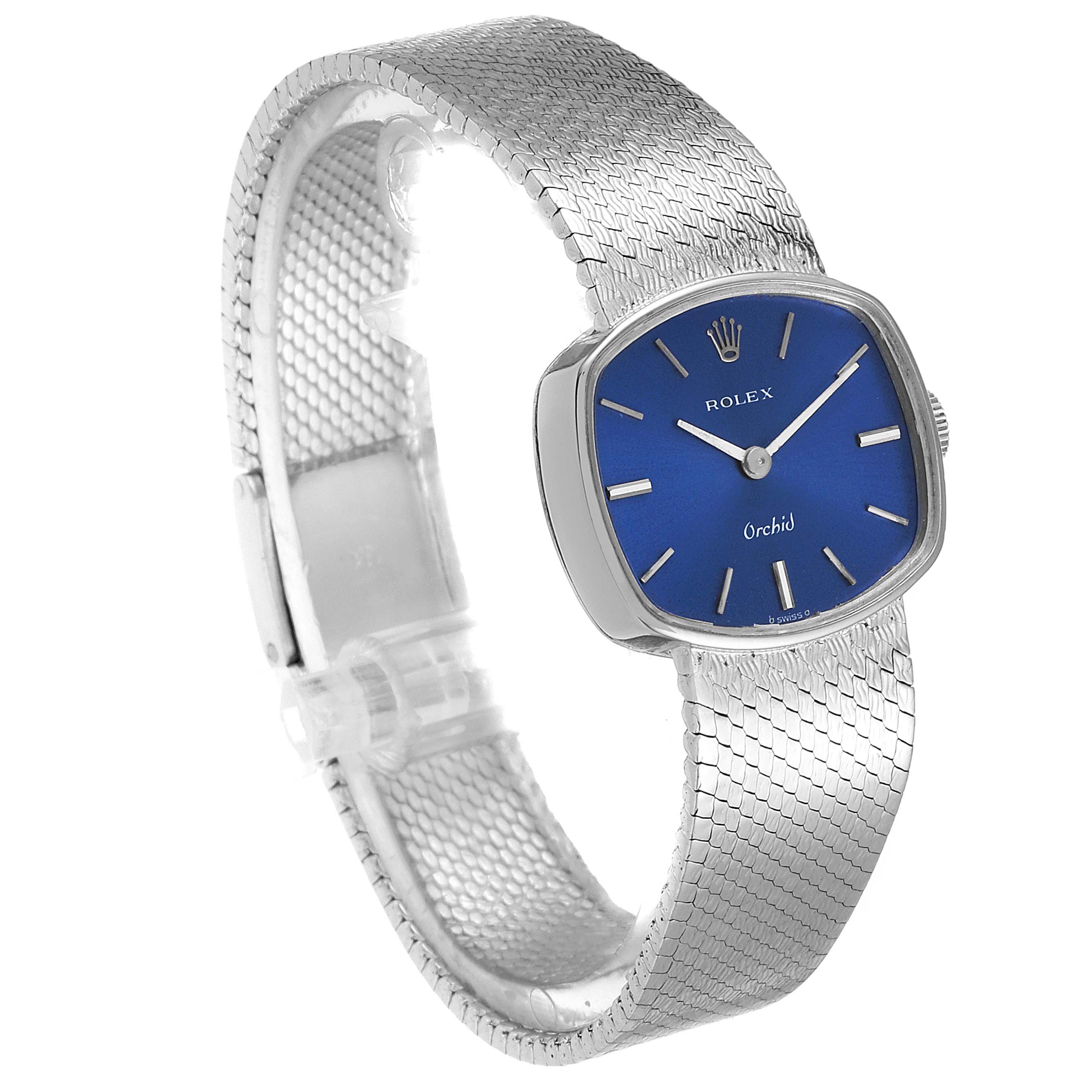 The image shows a Rolex Cocktail 2673 Women's White Gold Blue Dial 2673 Women's White Gold Blue Dial model watch with a blue dial, silver rectangular case, and a silver mesh bracelet.