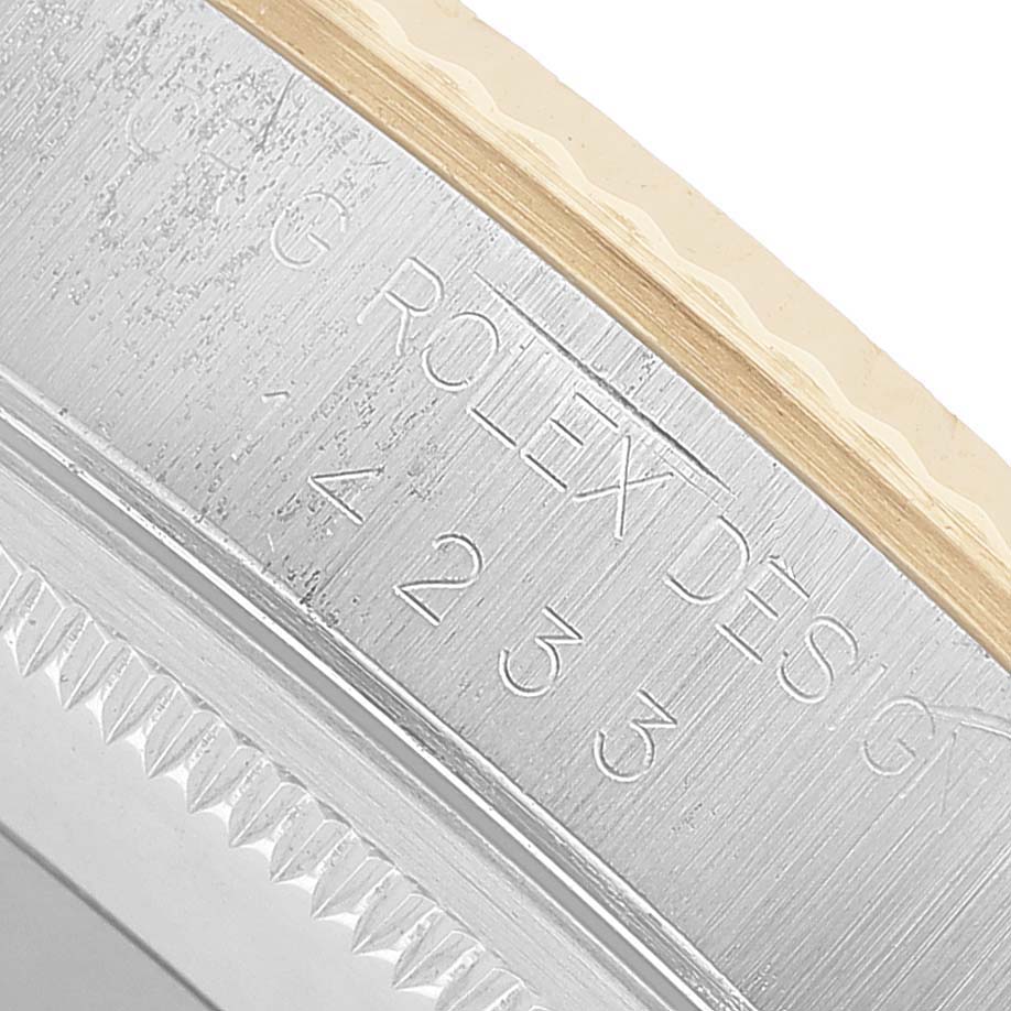 This image shows the engraved side of a Rolex Oyster Perpetual 14233 Men's Steel and Gold (two tone) Champagne Dial watch case with model details.