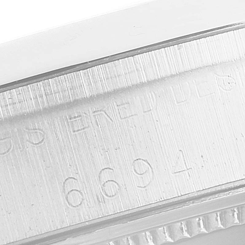 This image shows a close-up view of the case side with engraved serial numbers of the Rolex Vintage Collection 6694 Men's Stainless Steel Champagne Dial 6694 Men's Stainless Steel Champagne Dial model.