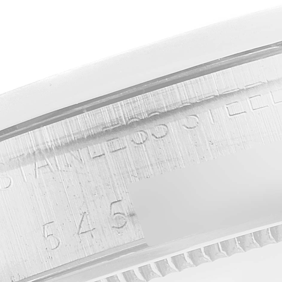 This image displays a close-up of the case side of a Vintage Collection Rolex watch, revealing engraved text details.
