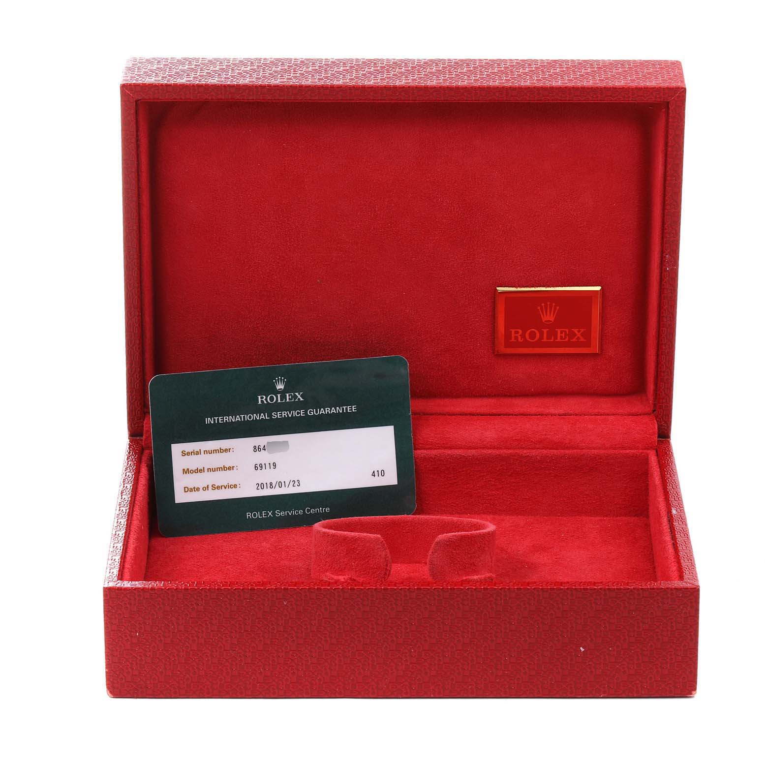 This image shows an empty red Rolex box for the President model watch, along with a service guarantee card.