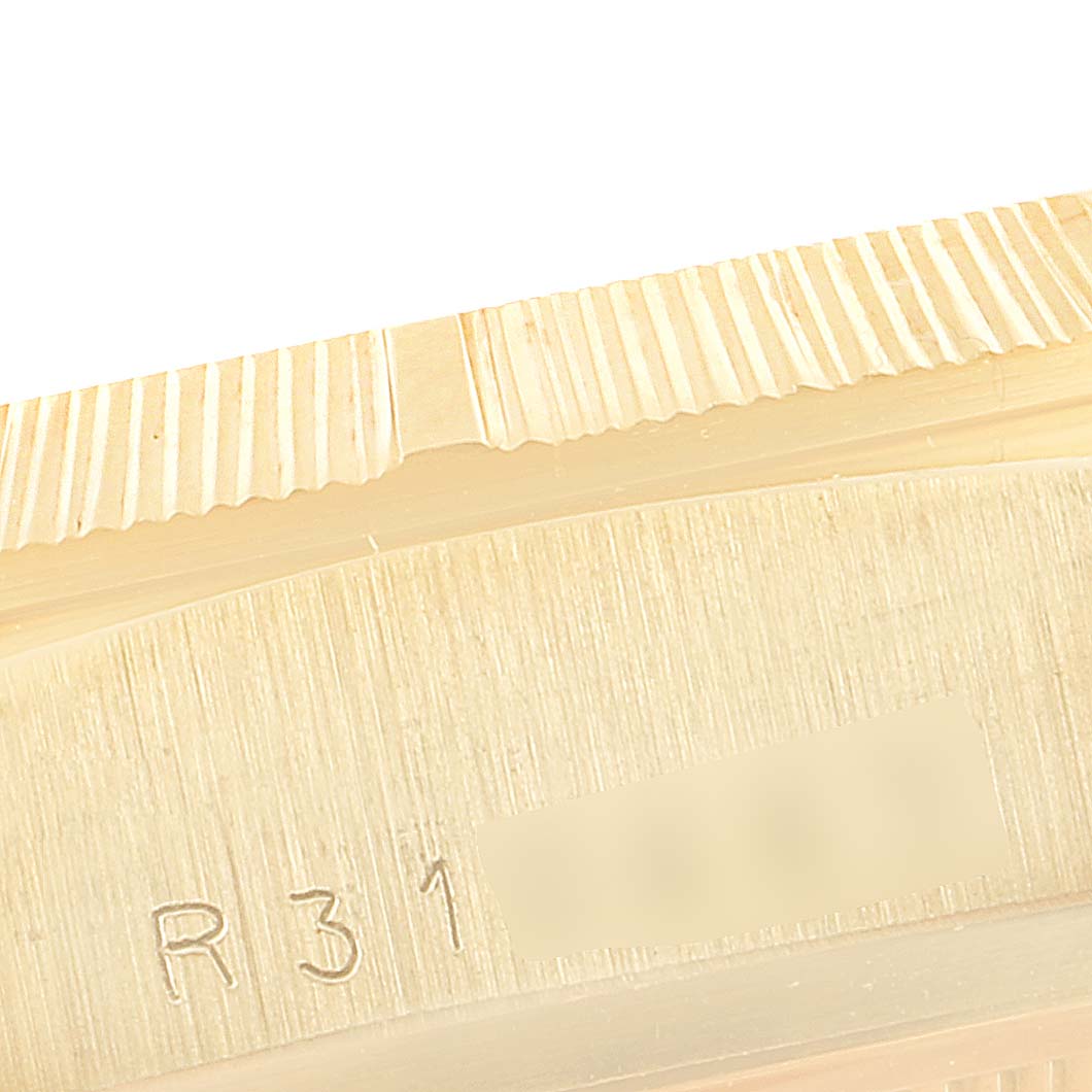 The image shows a close-up of the fluted bezel and part of the case back of a Rolex President 18078 Men
s Yellow Gold White Dial 18078 Men
s Yellow Gold White Dial model watch.