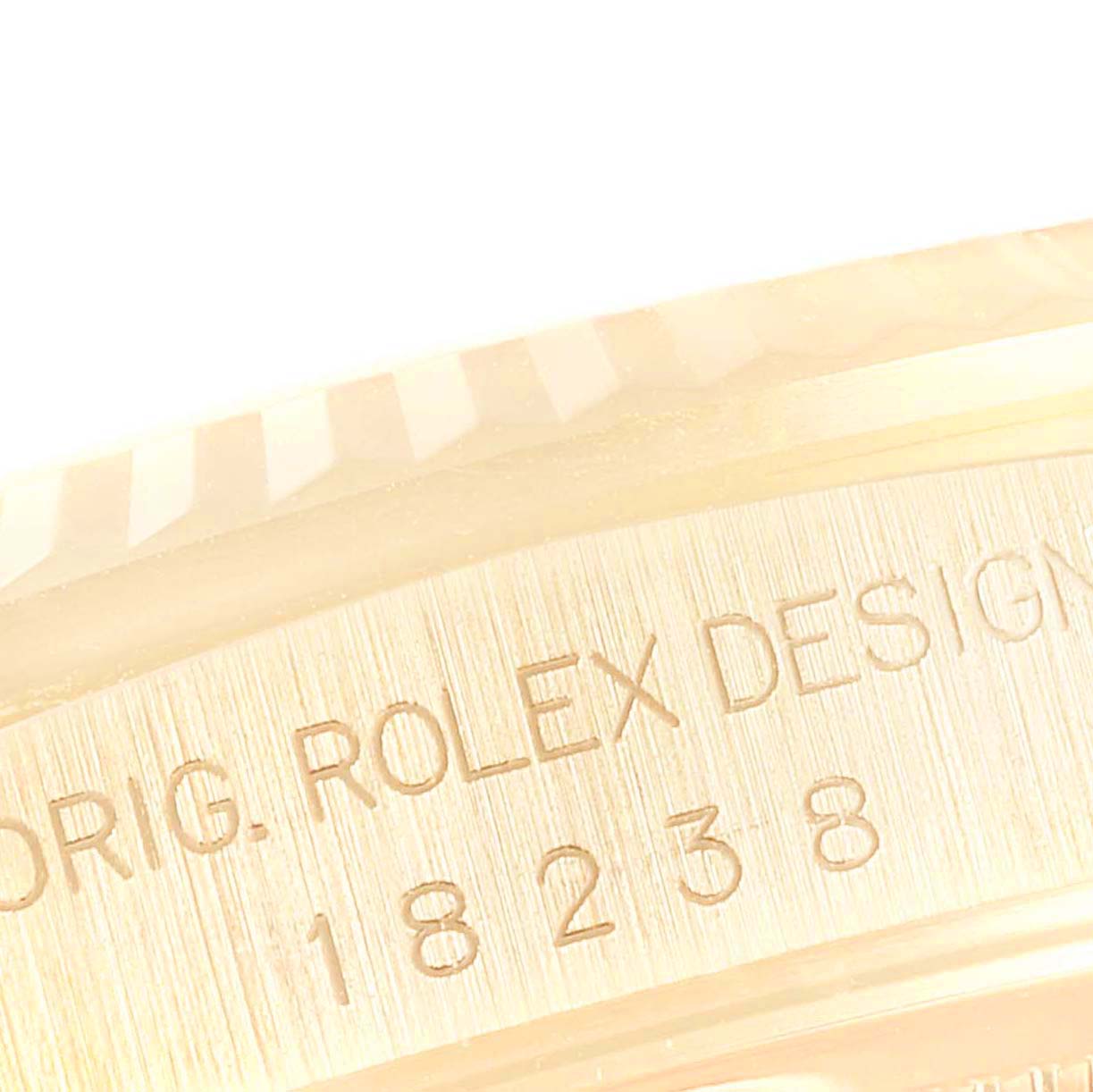 The image shows a close-up angle of the engraving on the Rolex President 18238 Men
s Yellow Gold Champagne Dial 18238 Men
s Yellow Gold Champagne Dial watch model, highlighting the design and model number.