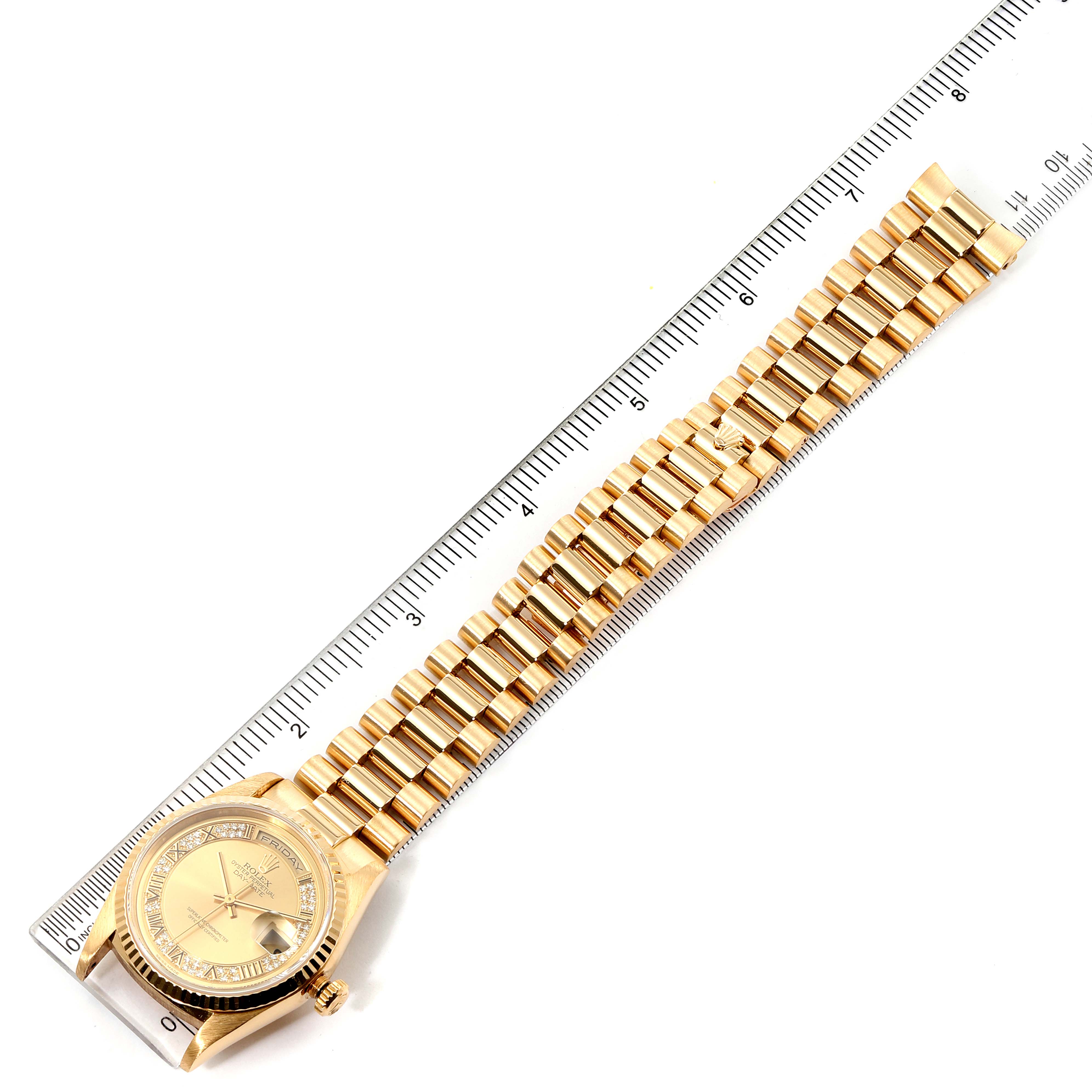 The image shows a top-down view of a Rolex President 18238 Men
s Yellow Gold Champagne Dial 18238 Men
s Yellow Gold Champagne Dial model watch, with its full band and face displayed alongside a ruler for scale.