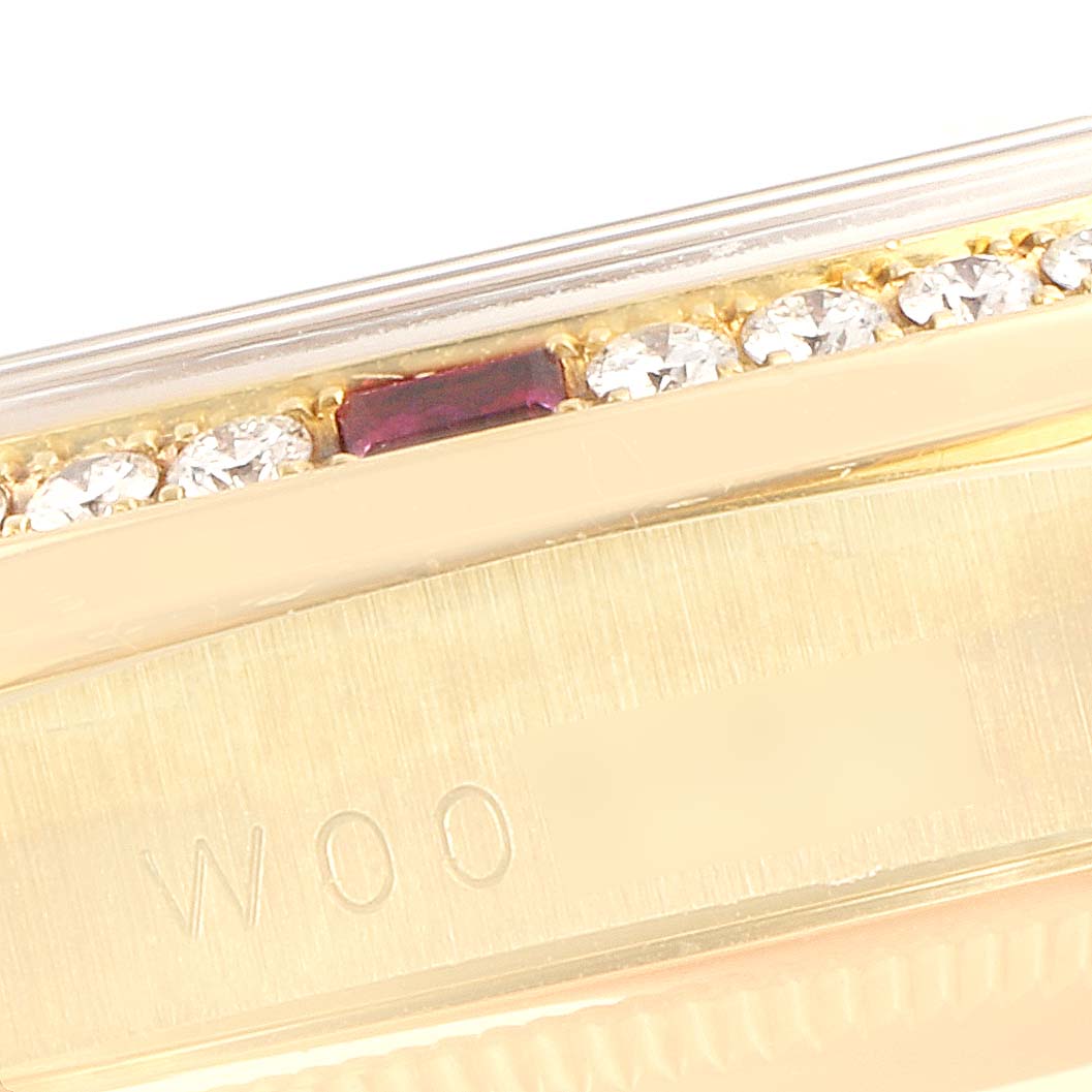 This image shows a close-up of the bezel and engraved case of a Rolex President 18378 Men's Yellow Gold Champagne Dial 18378 Men's Yellow Gold Champagne Dial model, featuring diamonds and a ruby.